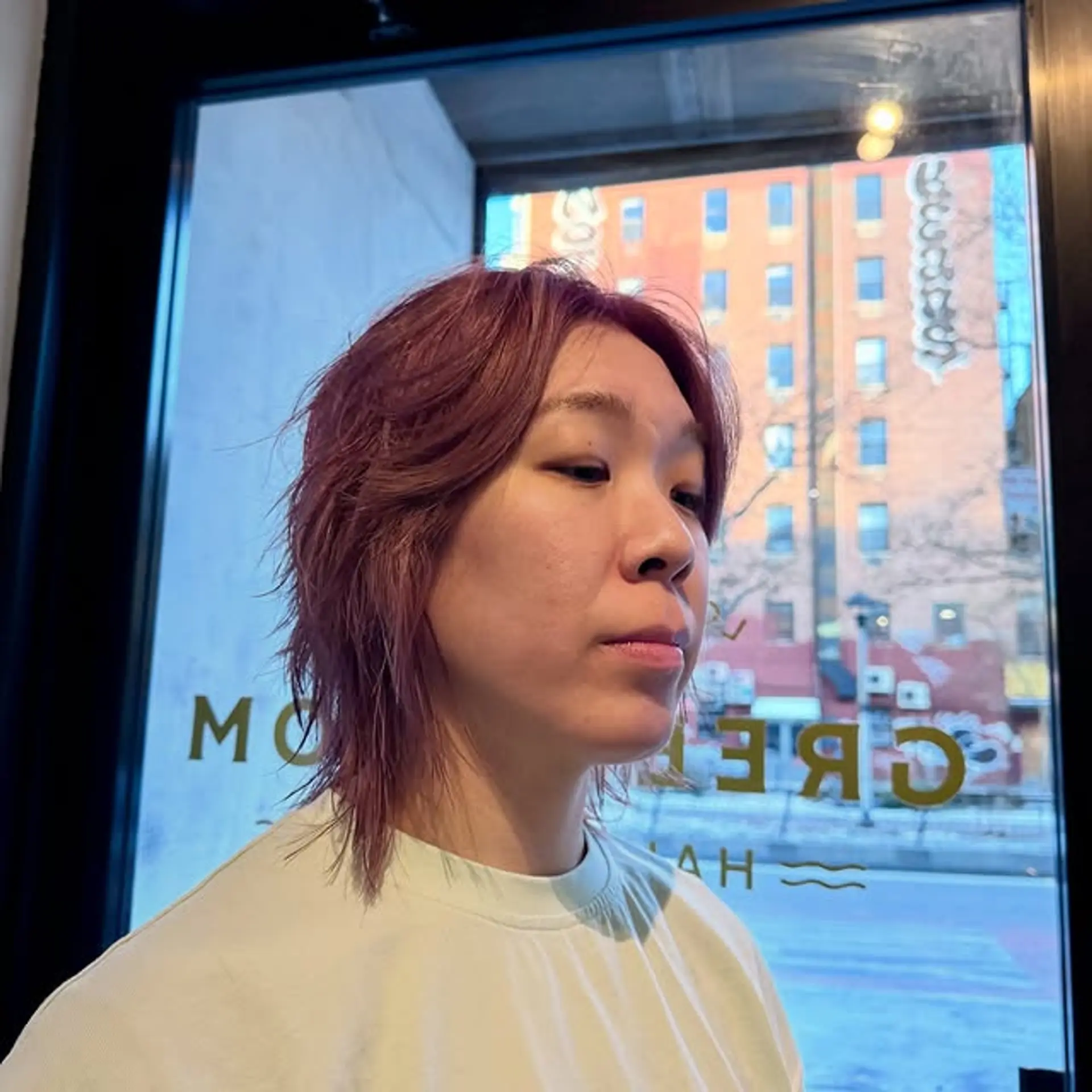 A modern, edgy shaggy mullet haircut with textured ends and choppy layers. 1