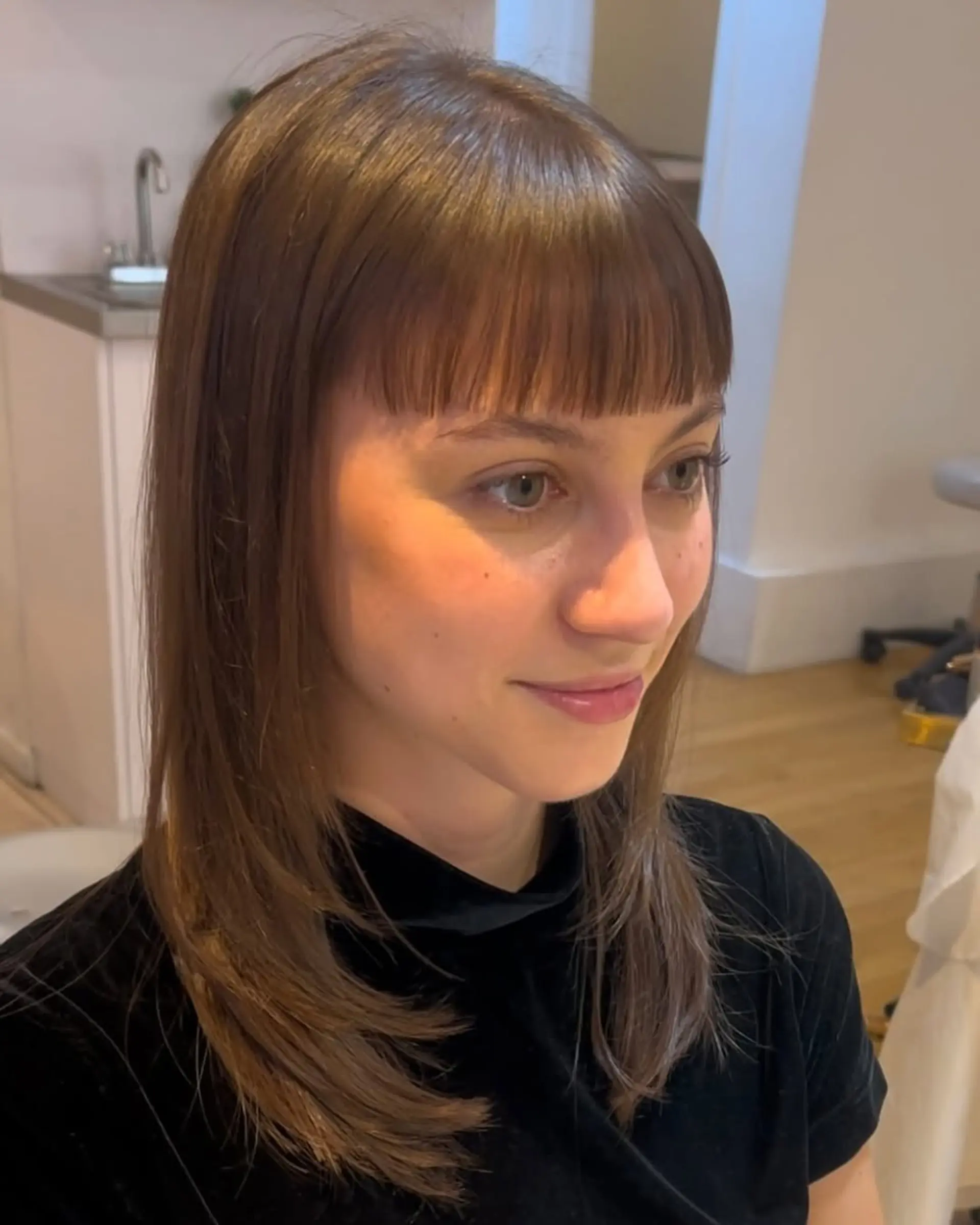 A medium-length shag with layered sections and bardot bangs. 1