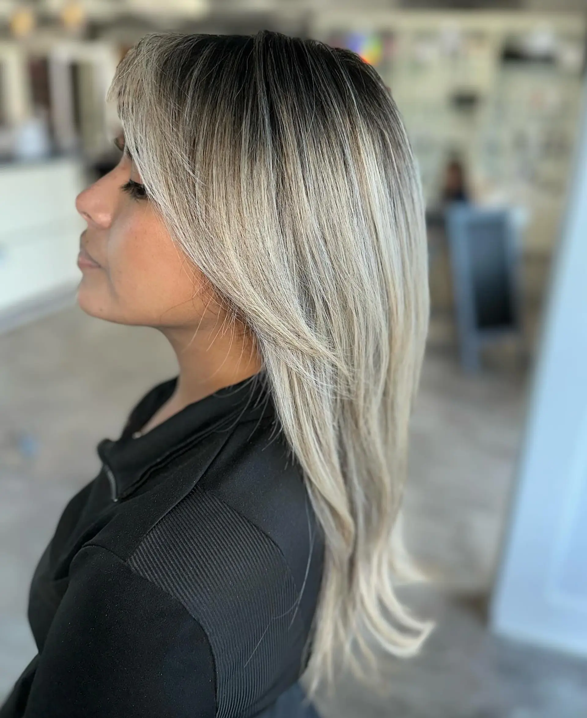 Long, layered straight hair with full bangs and subtle layers for face-framing. 1