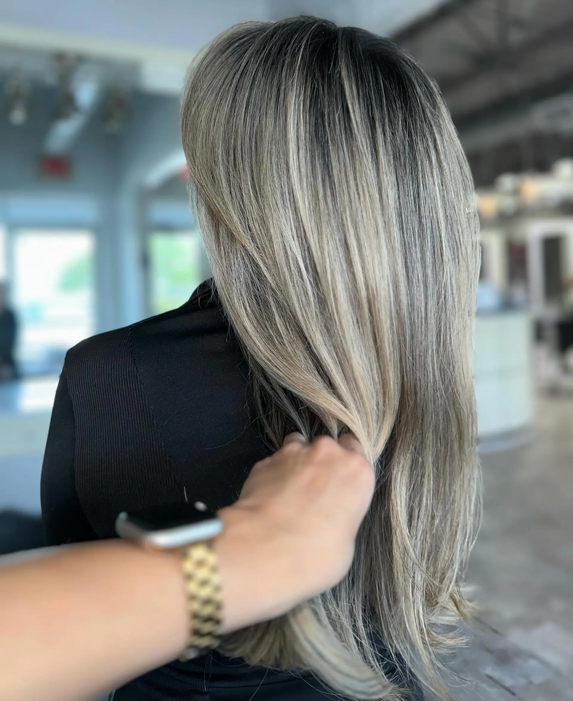 Long, layered straight hair with full bangs and subtle layers for face-framing. 2