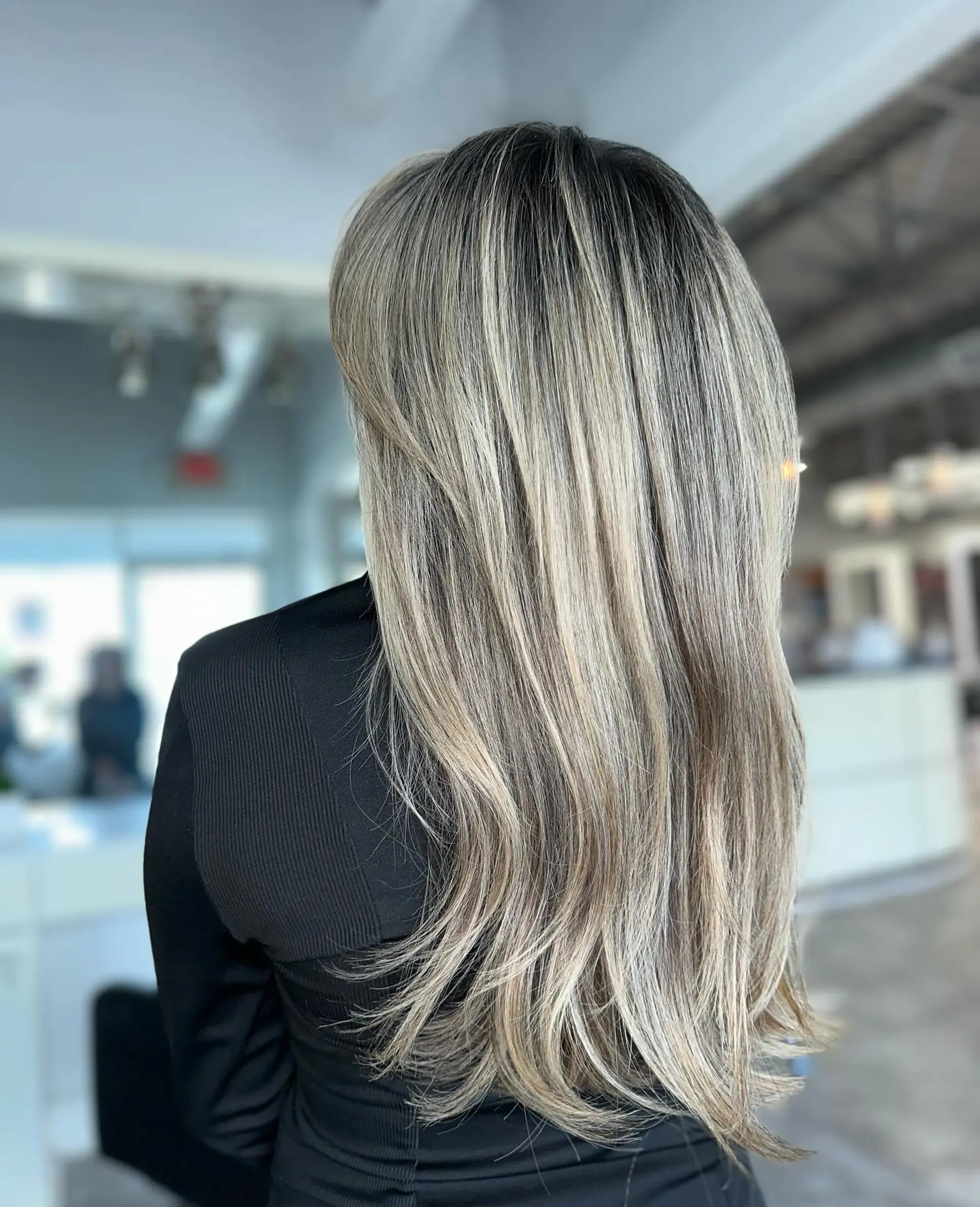 Long, layered straight hair with full bangs and subtle layers for face-framing. 3