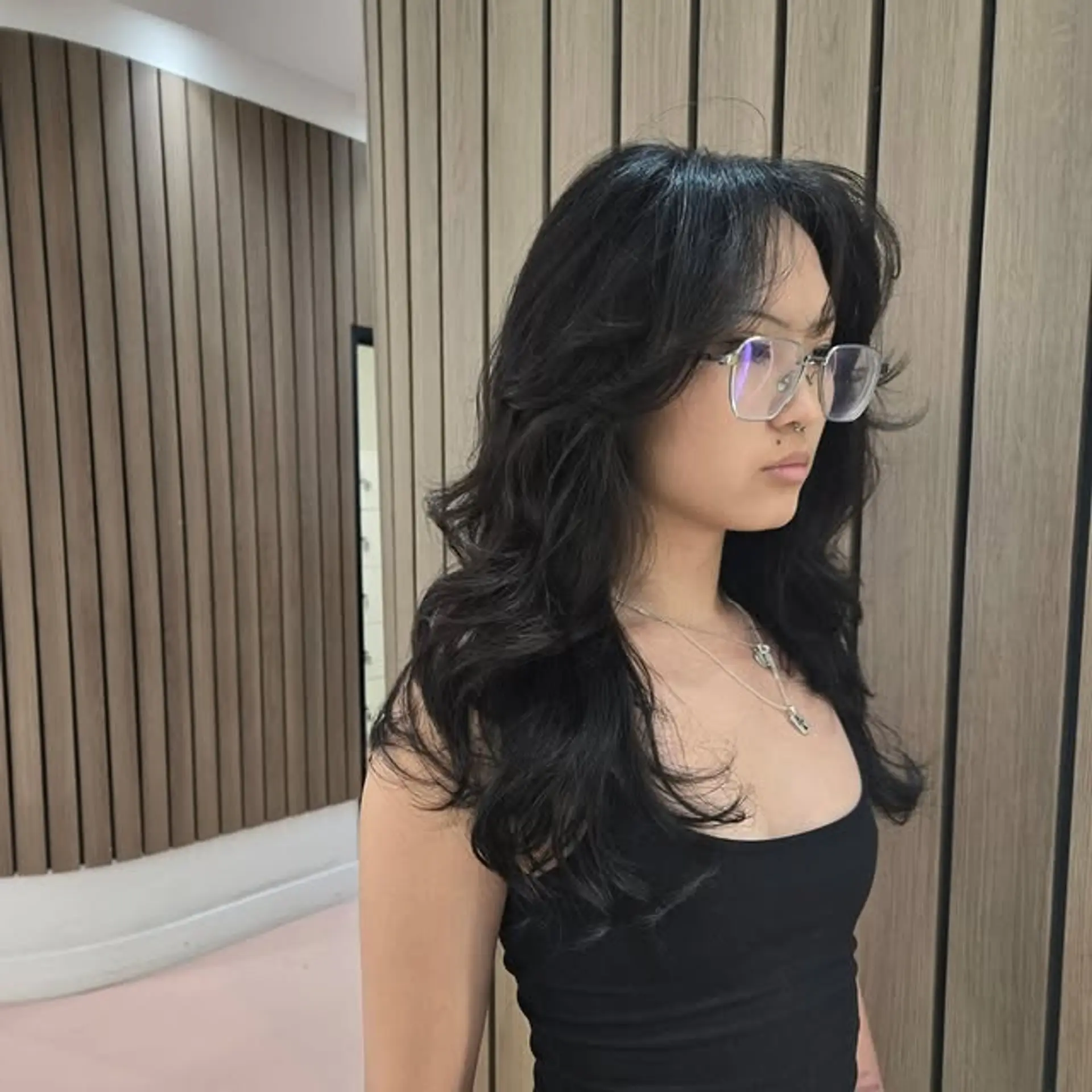 A layered wolf cut with wispy curtain bangs. 1