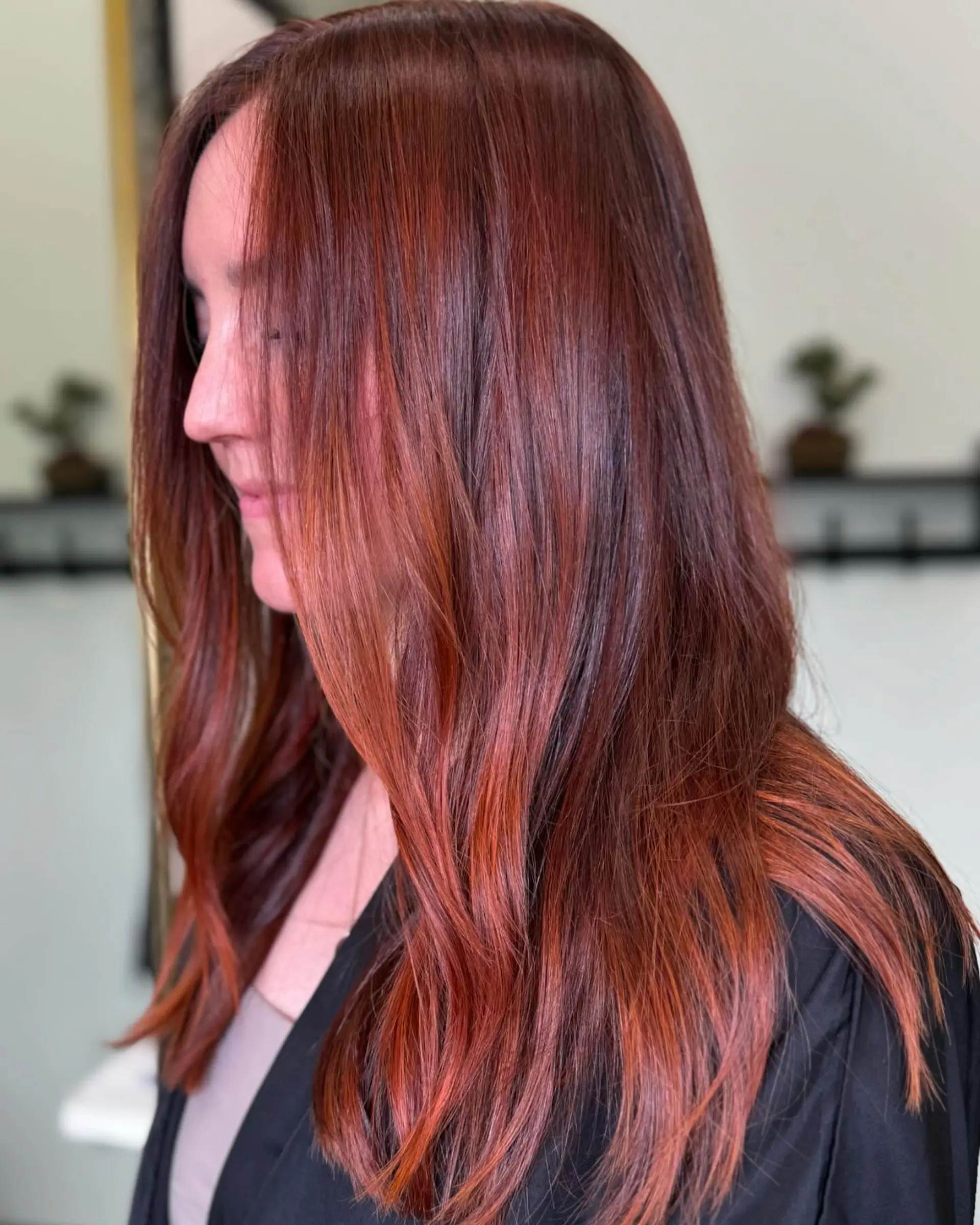 Vibrant cowboy copper hair with seamless auburn undertones styled in a smooth, polished blowout. 1