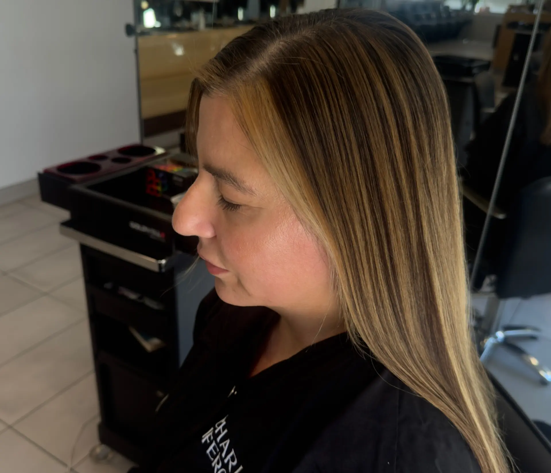 Long, sleek straight hair featuring finely blended honey blonde highlights with bright face-framing strands. 1