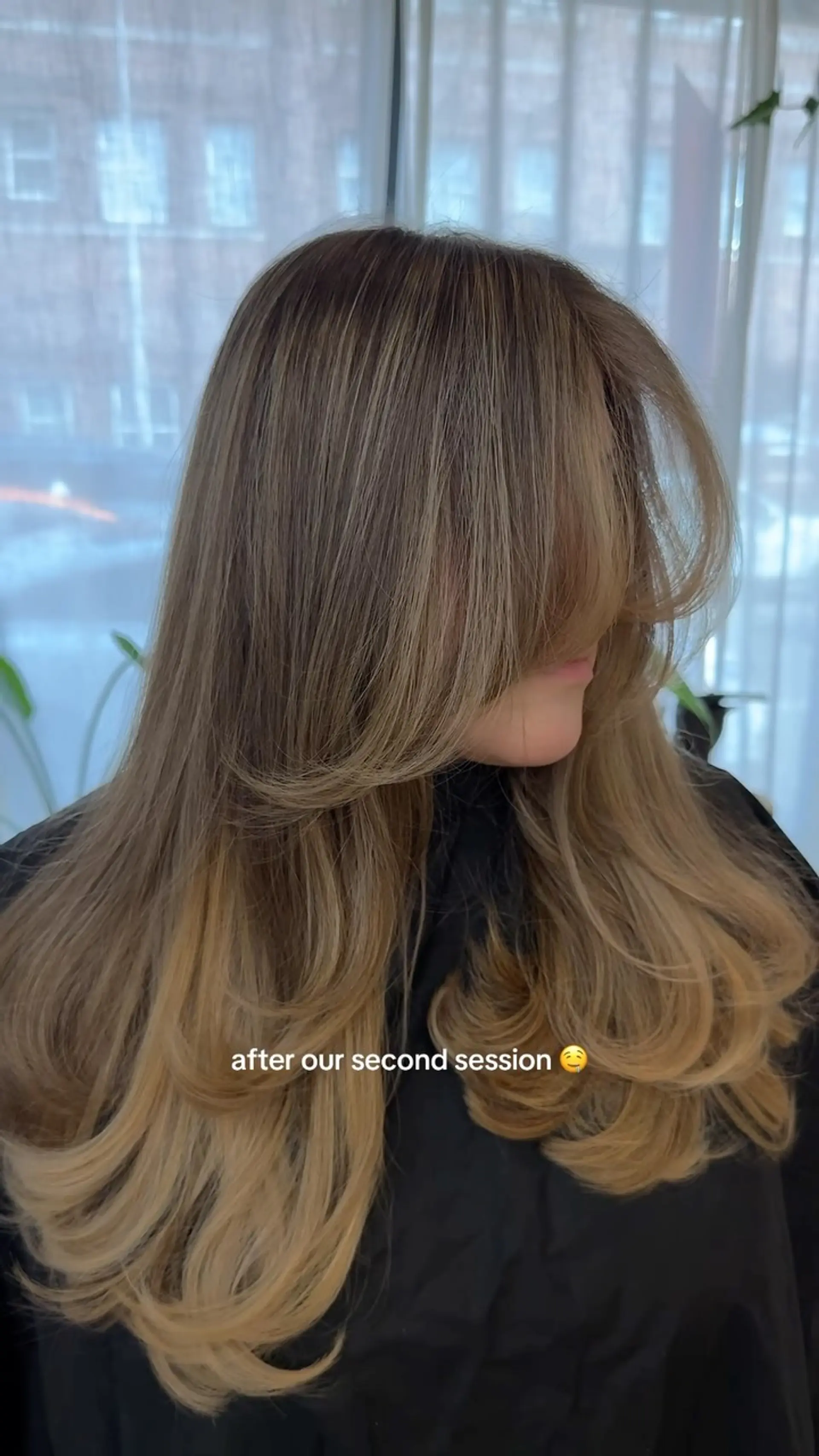 Voluminous long layered blowout with face-framing curtain bangs and curled ends. 1