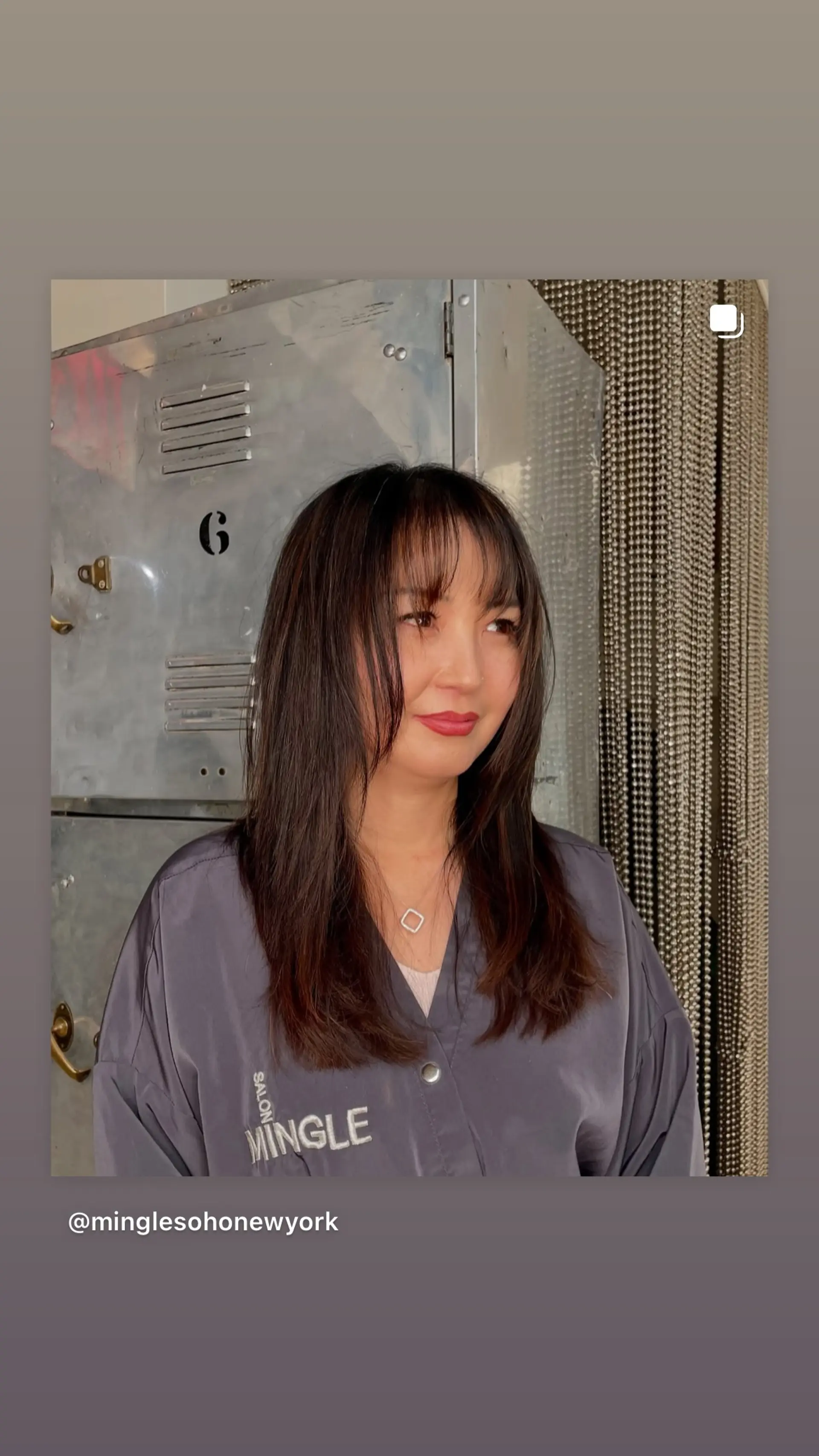 A trendy medium-length layered lob haircut with wispy curtain bangs and textured ends. 1