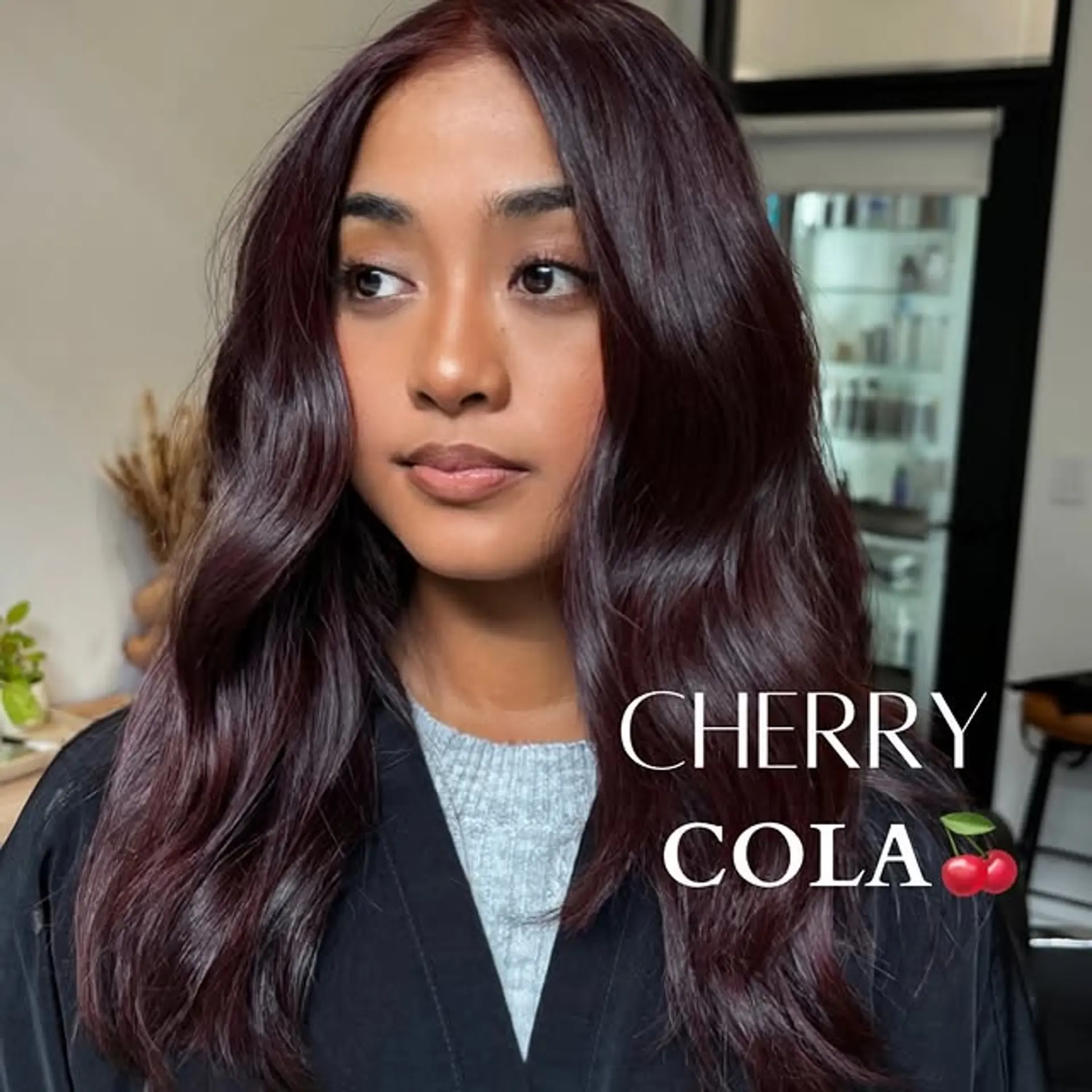 Medium length, wavy hairstyle with a rich cherry cola color. 1