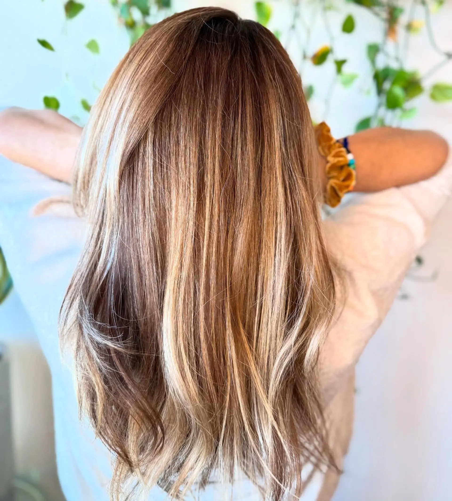 Long dimensional hair styled straight with a fine weave of warm honey and golden blonde highlights over a soft brown base. 1