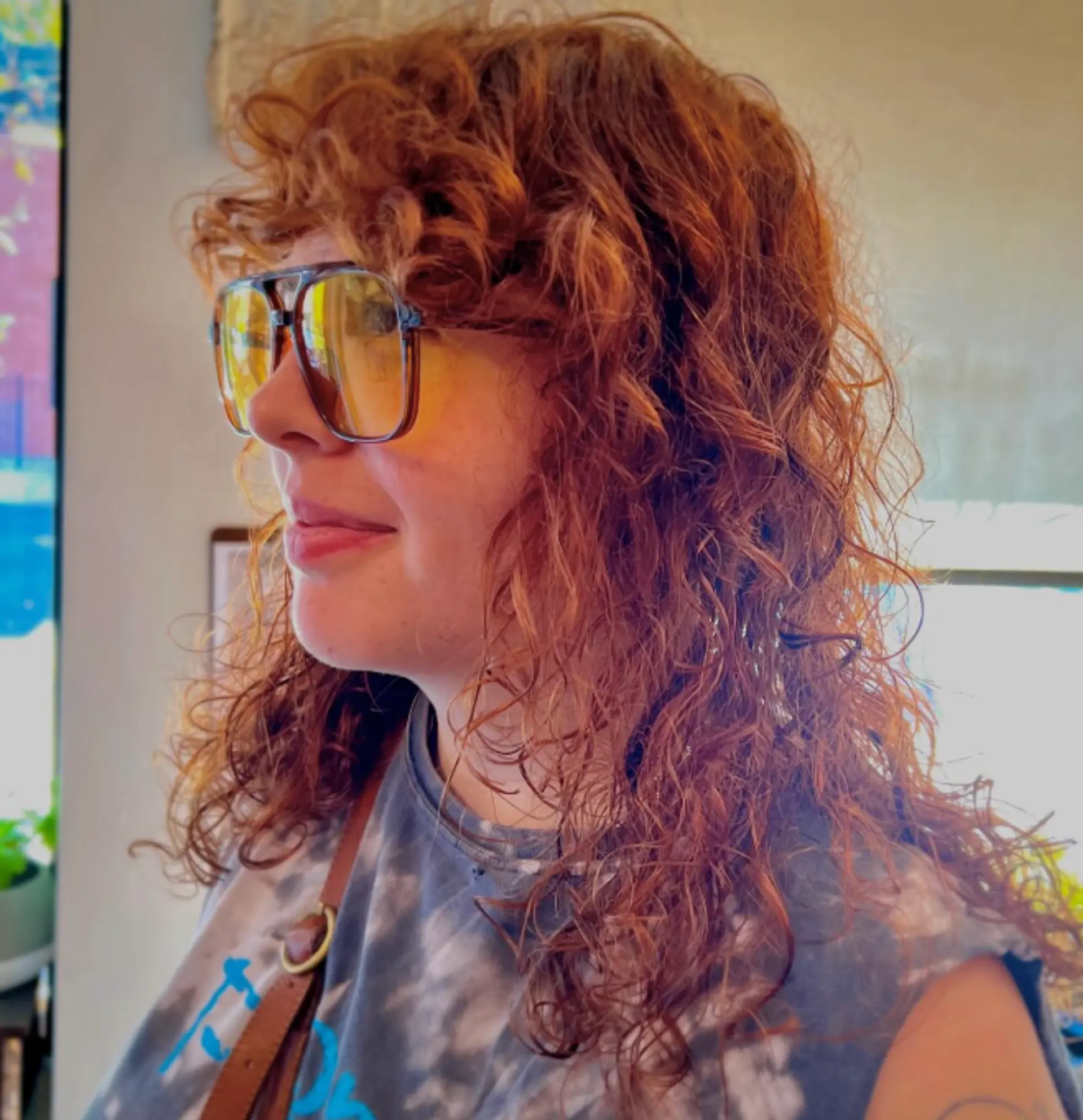 A curly, layered hairstyle that enhances natural volume and texture. 1