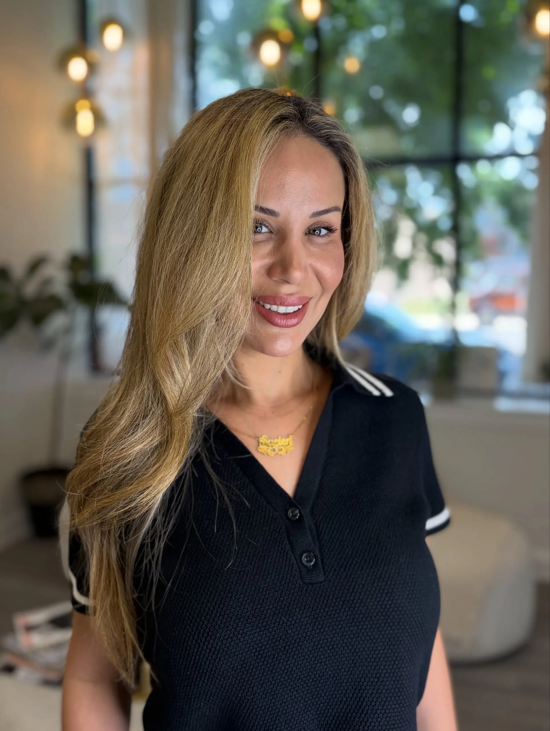 Long golden blonde hair styled in a smooth, voluminous blowout with gentle curved ends and a deep side part. 1