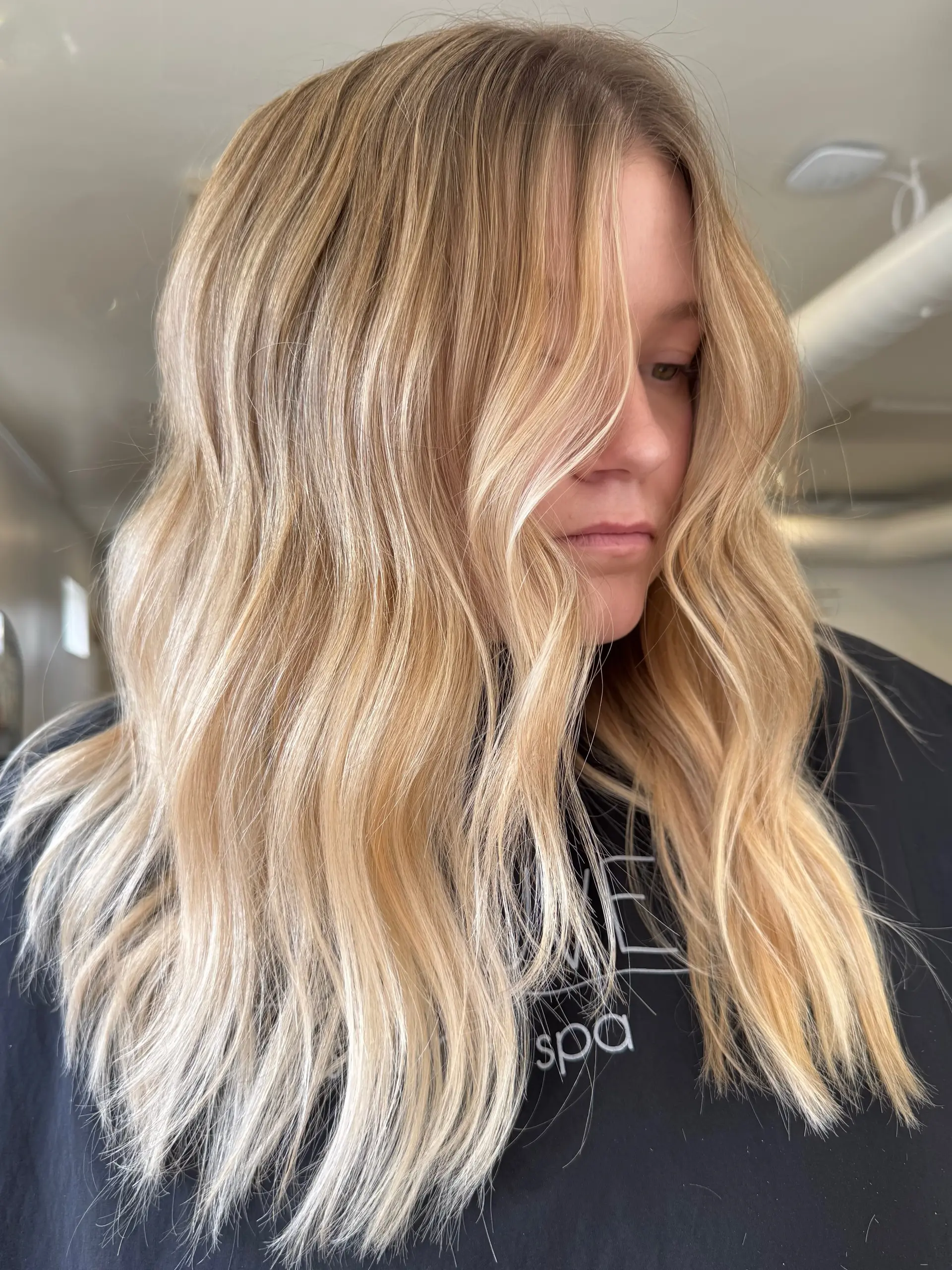 Dimensional golden blonde hair styled in soft, loose waves with face-framing pieces. 1