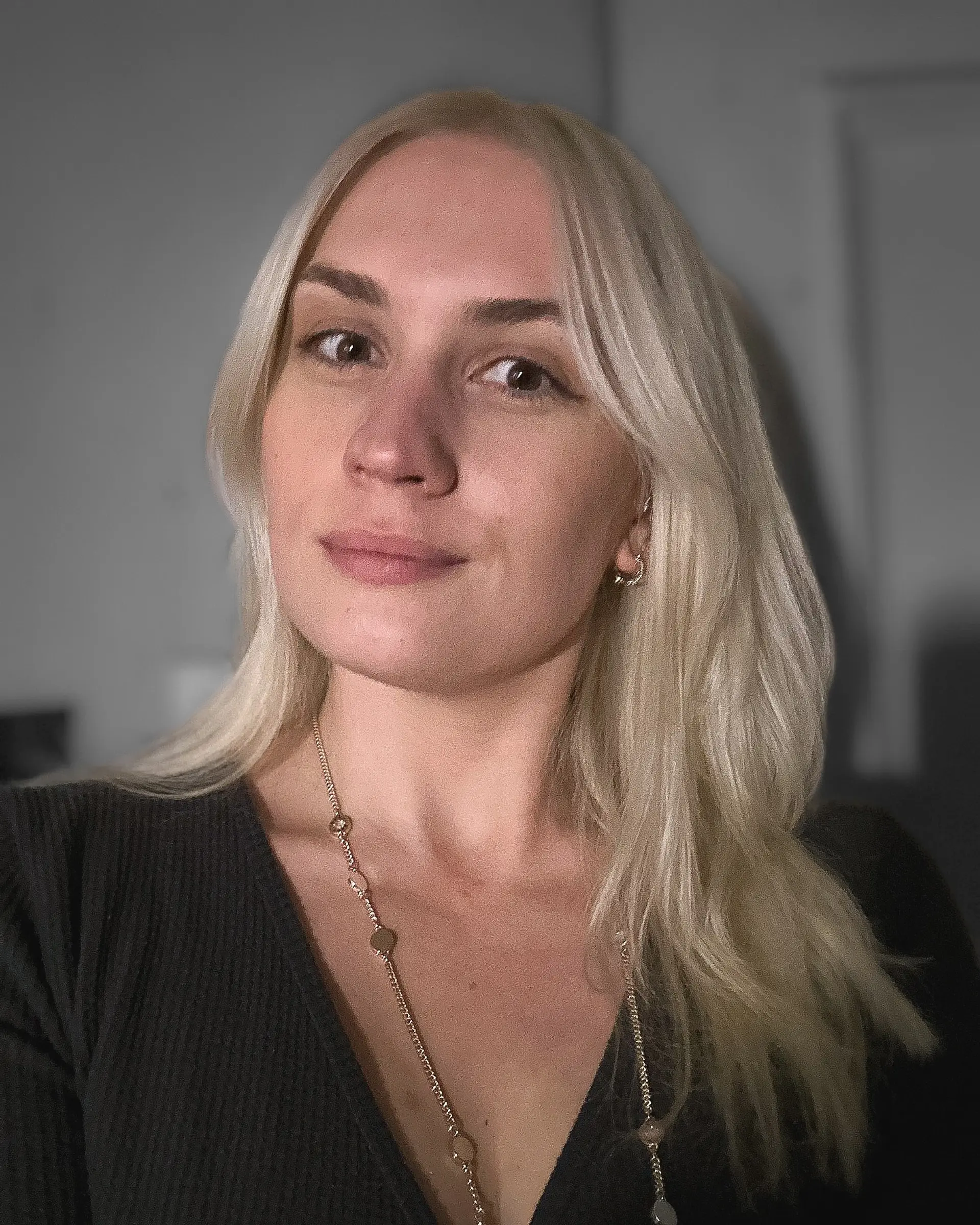 Medium-length bright platinum blonde hair with a clean center part and soft face-framing layers. 1