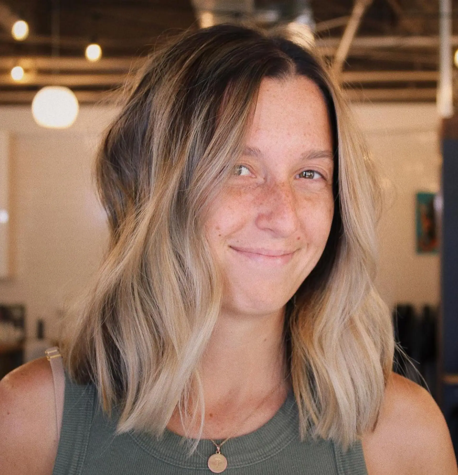 A collarbone-length textured lob with soft, lived-in waves and a blended blonde balayage. 1