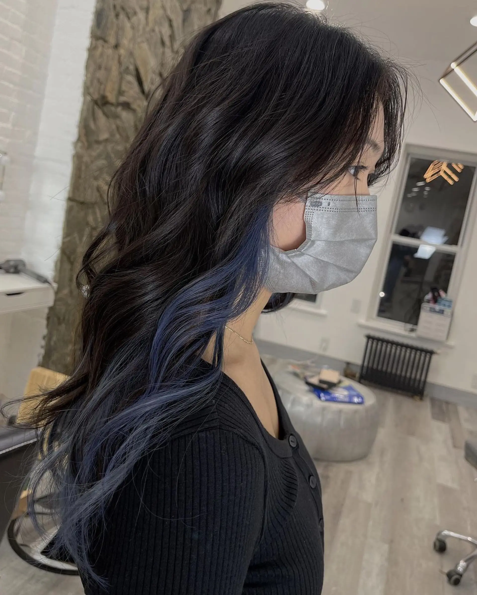 Medium-length, wavy hair with black to blue balayage, face-framing layers, and a stylish, voluminous texture. 2