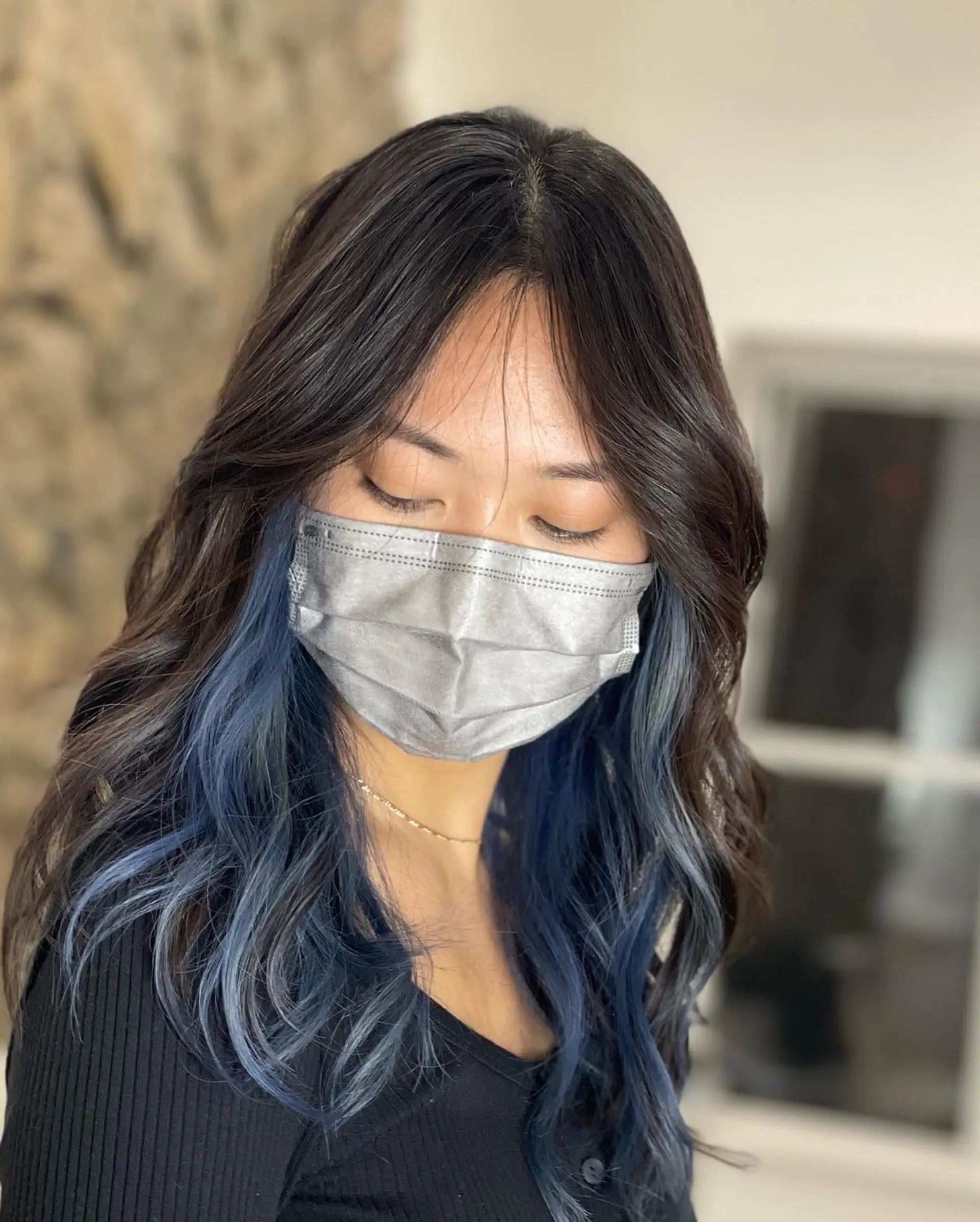 Medium-length, wavy hair with black to blue balayage, face-framing layers, and a stylish, voluminous texture. 1