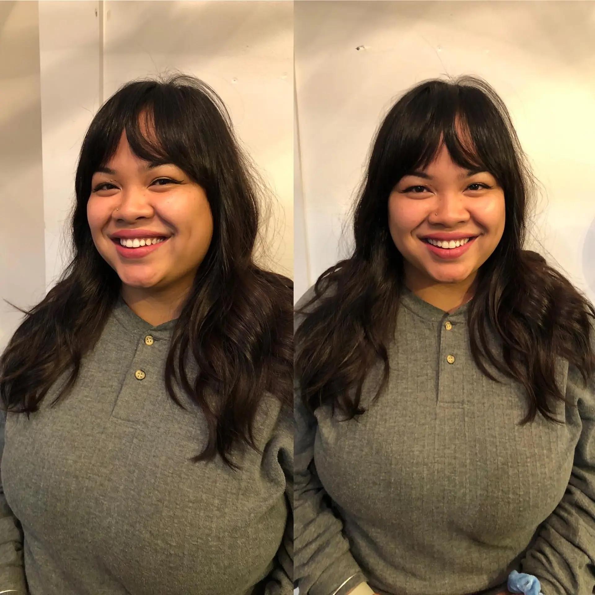Medium-length dark brown hair cut with soft curtain bangs and styled in loose, tousled waves. 1
