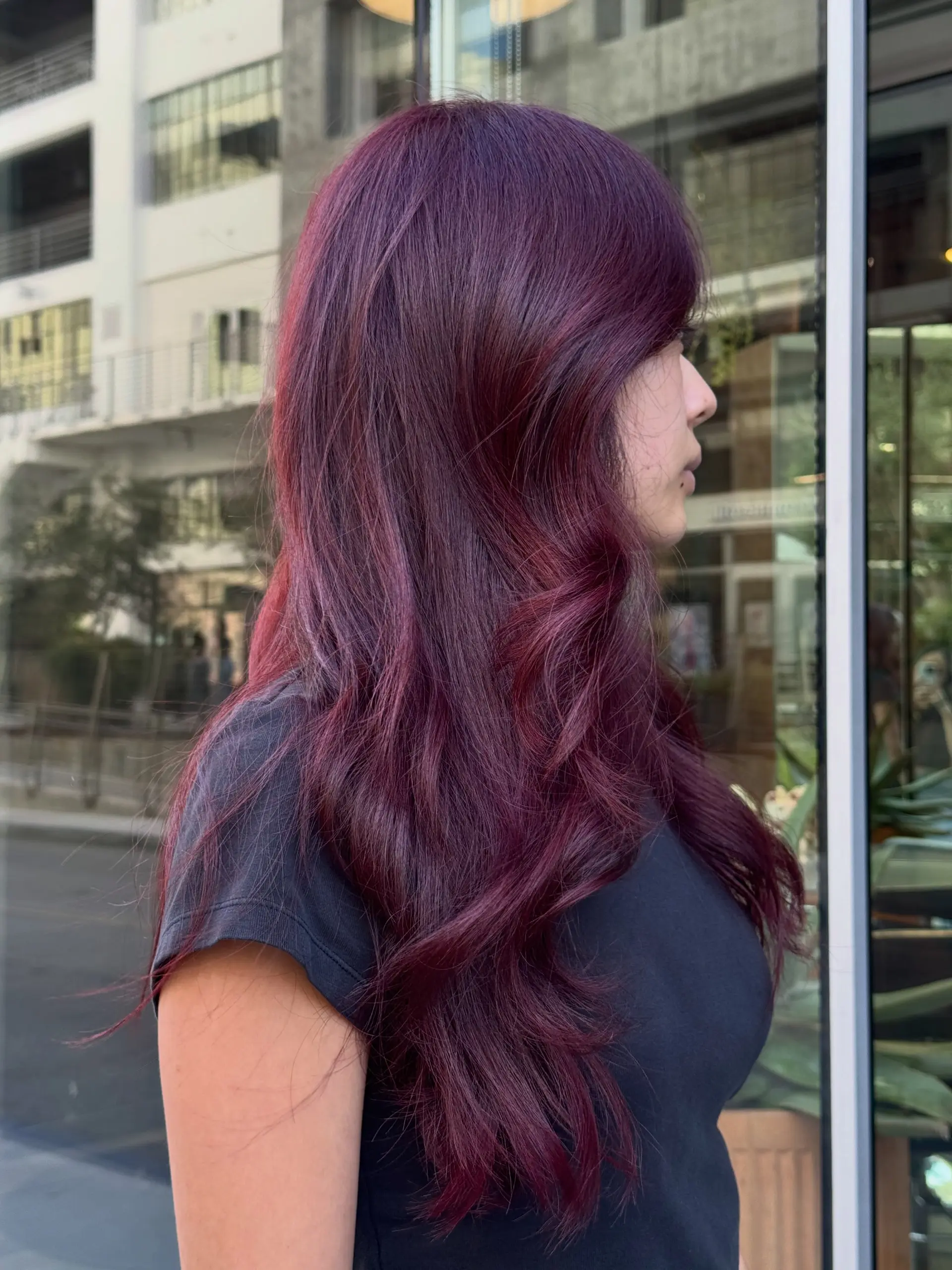 Vibrant cherry red all-over color styled into long, soft layers with gentle waves. 1