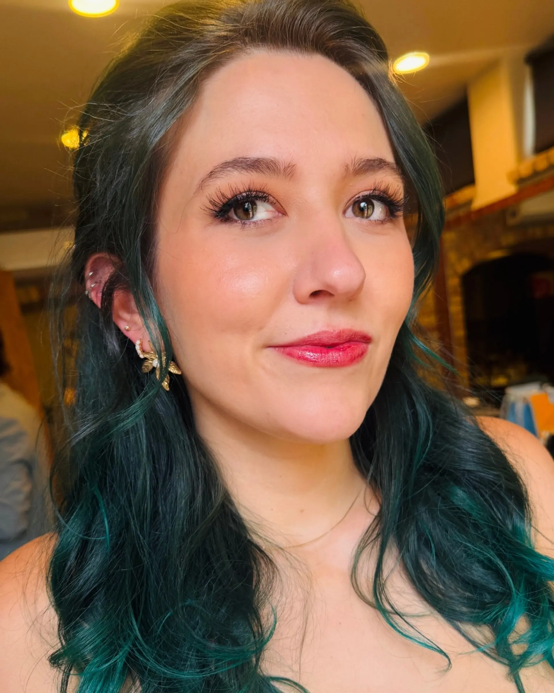Long deep emerald green and teal hair styled in soft, cascading waves with subtle face-framing pieces. 1