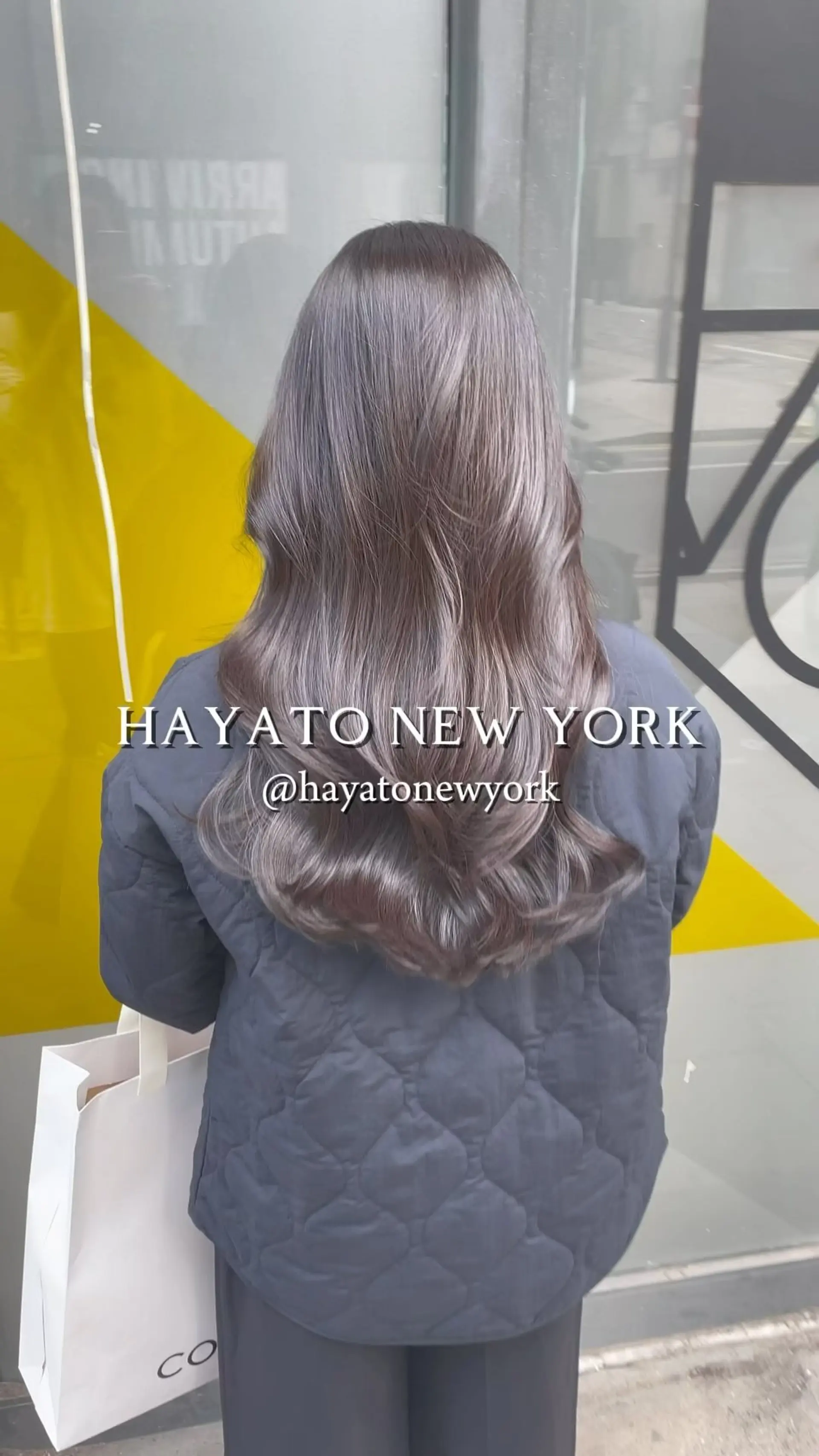 Long cool-toned ash brown hair cut in soft layers and styled with voluminous curved waves at the ends. 1