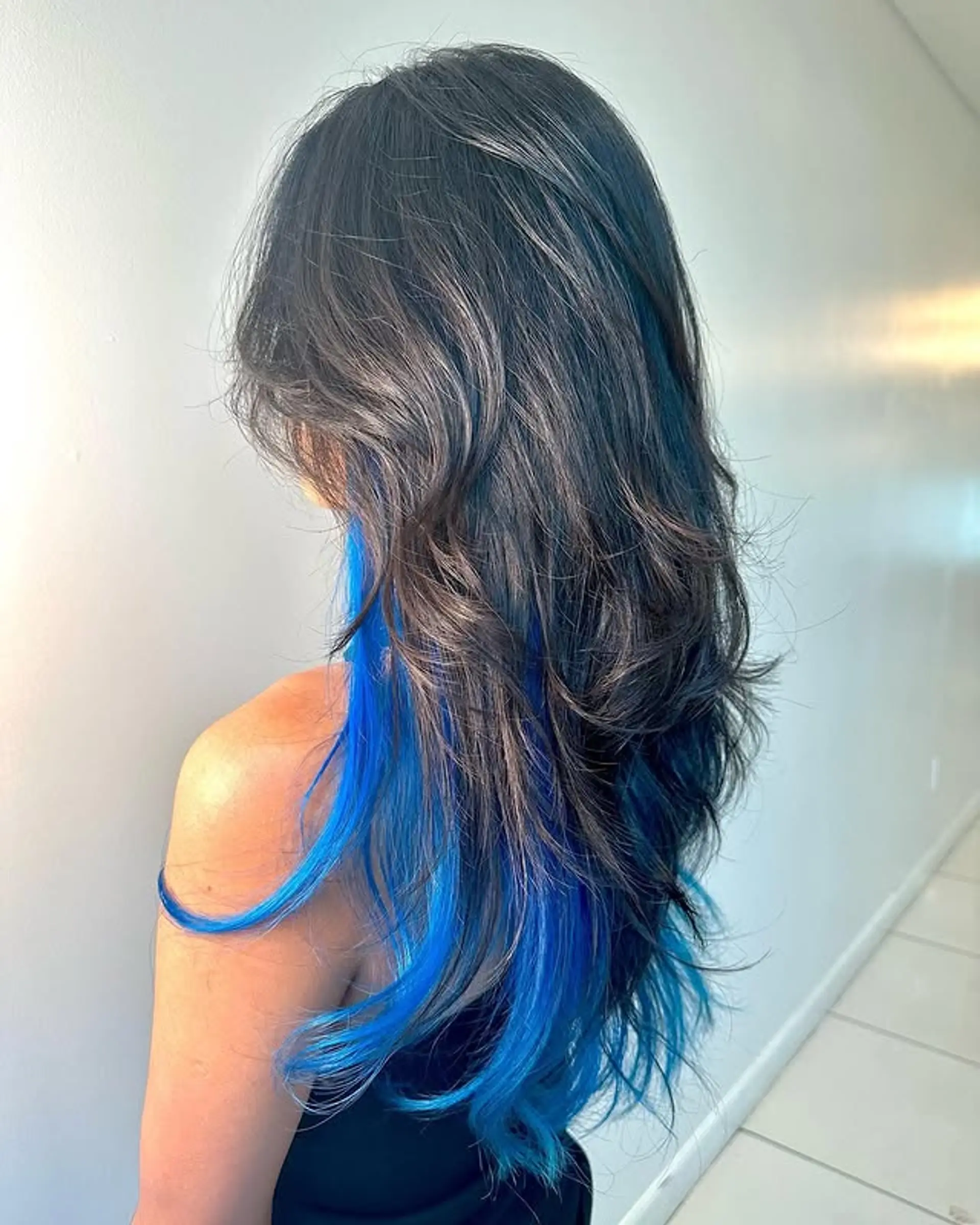 Long layered hair with face-framing electric blue highlights. 1