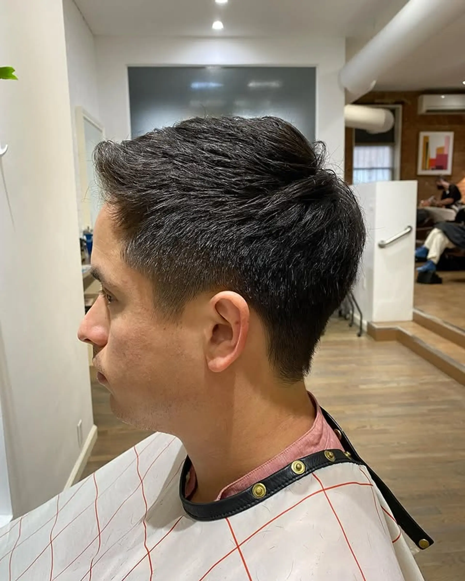 A stylish short haircut with a textured top and faded sides. 1