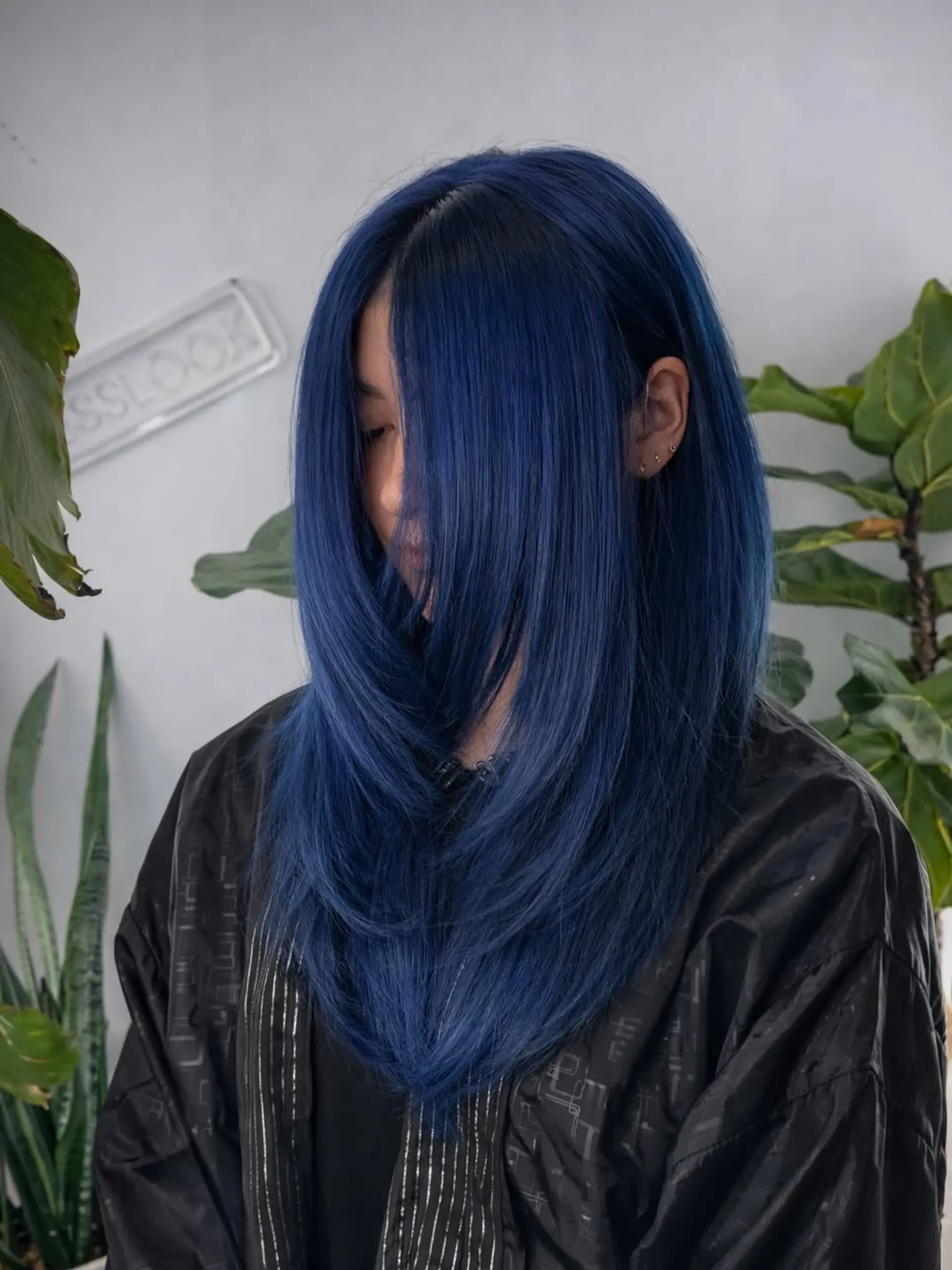 A sleek, long haircut with precision layers that create a subtle V-shape, finished with a bold, vibrant blue semi-permanent hair color. 1