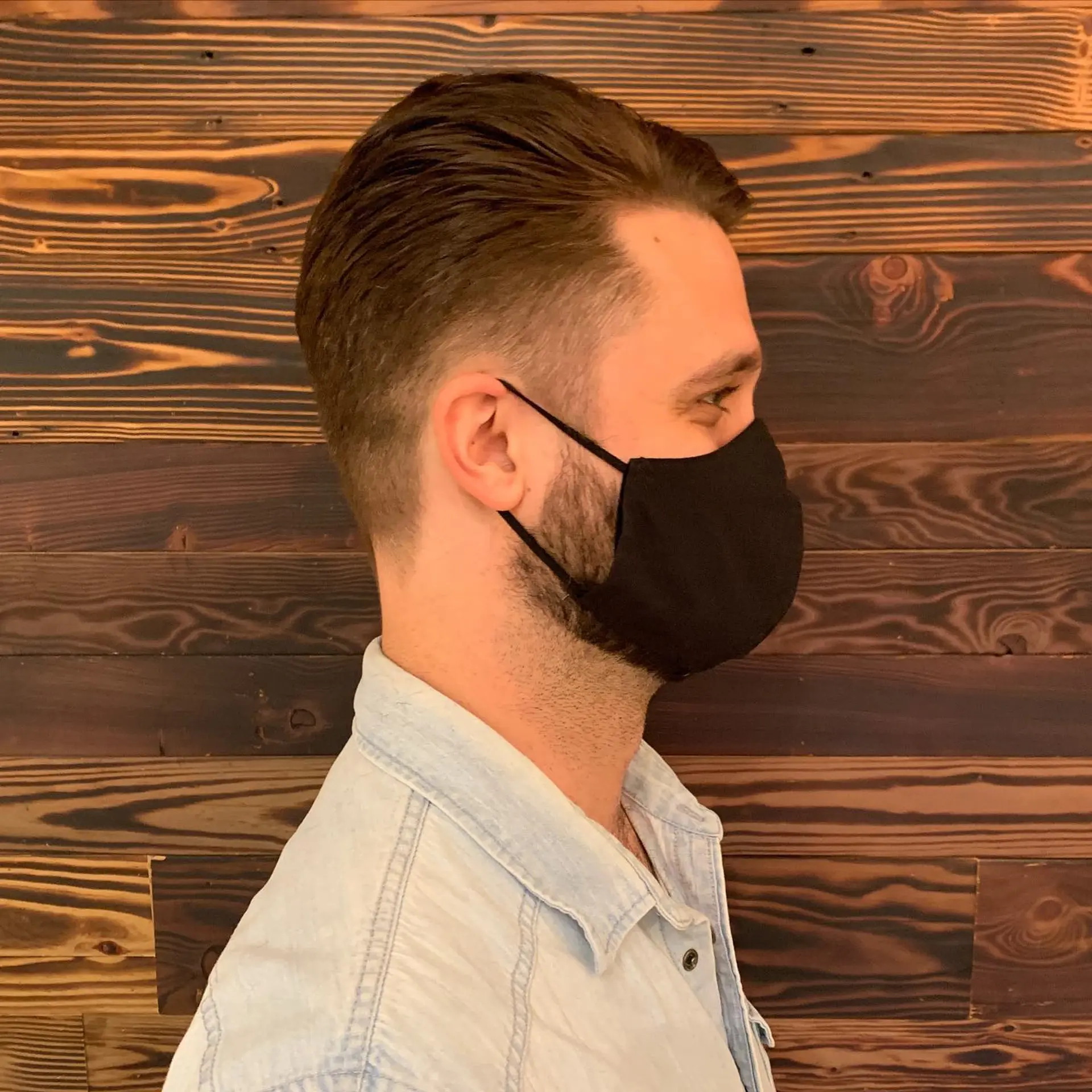 A classic taper fade haircut with a clean, modern look and textured top. 2