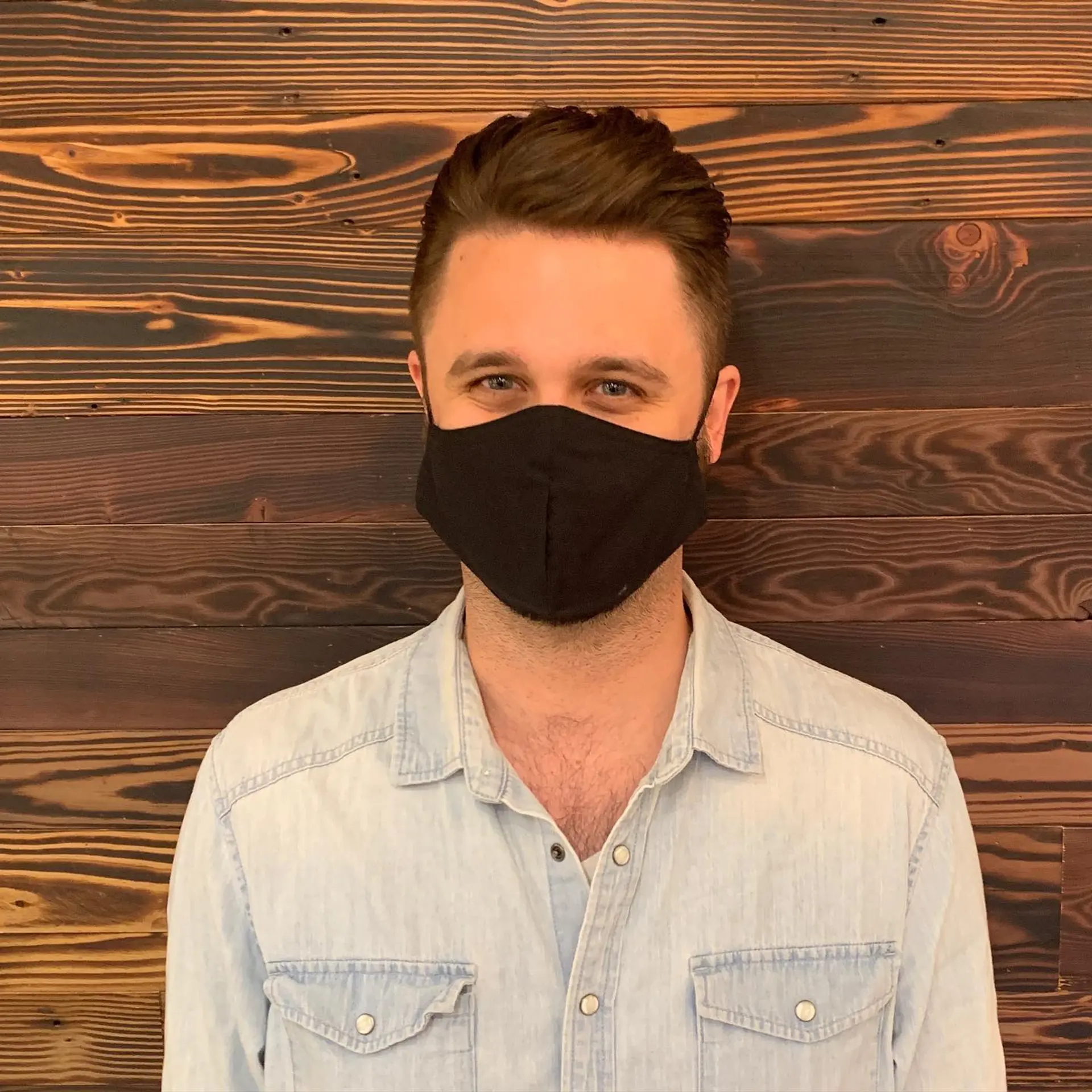 A classic taper fade haircut with a clean, modern look and textured top. 3