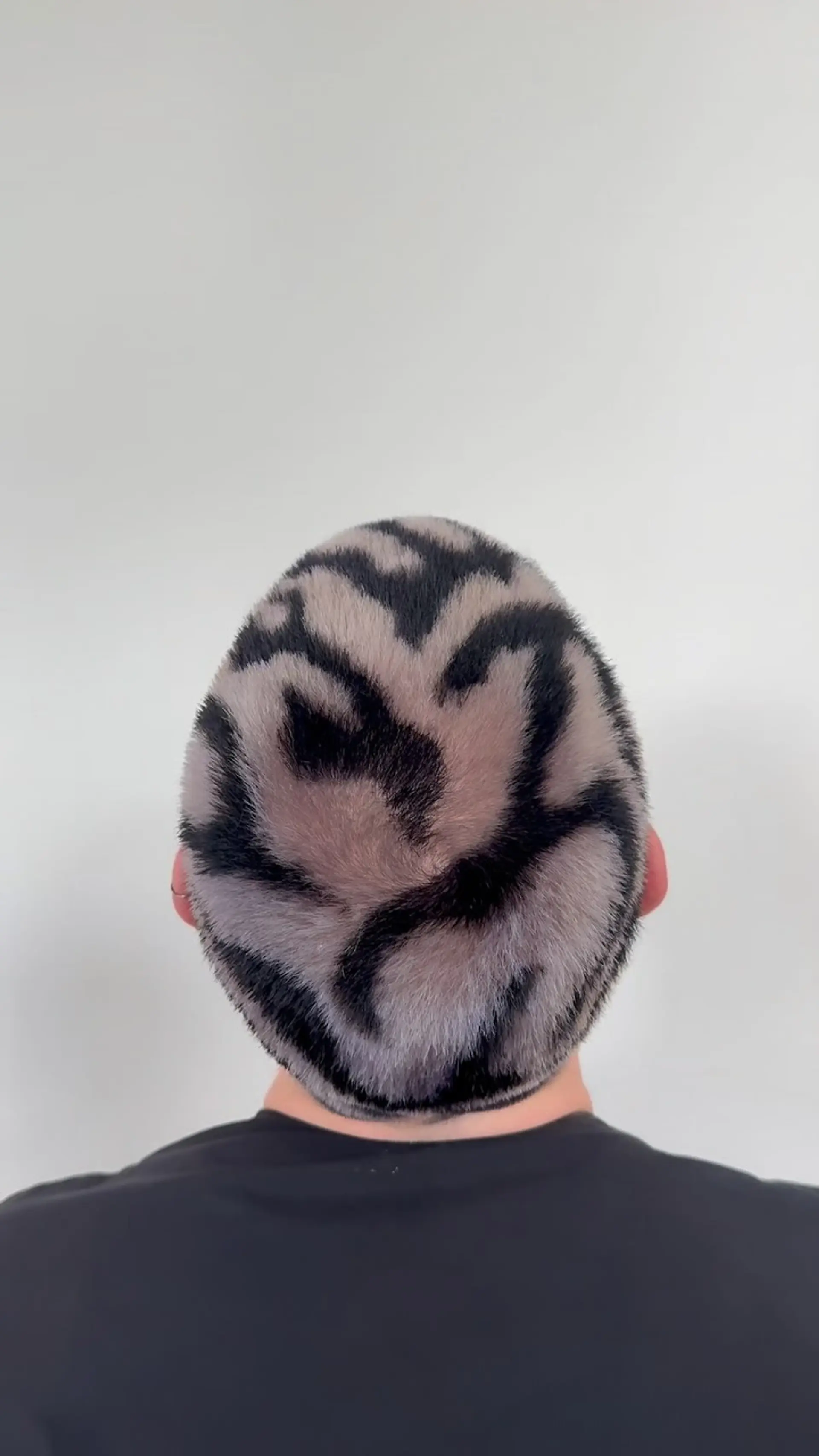 A platinum blonde buzz cut featuring painted black zebra stripes across the entire head. 1