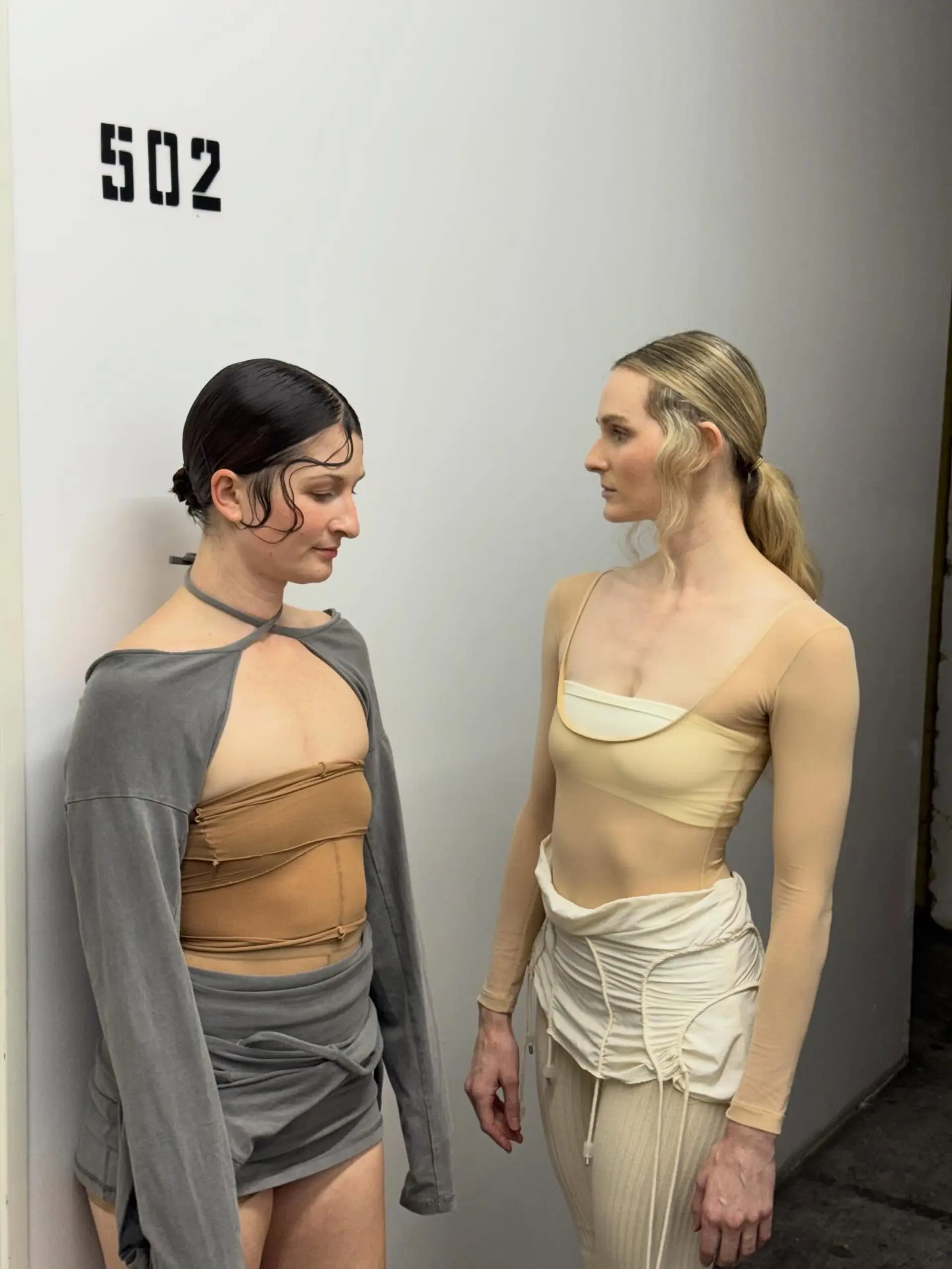 Editorial styles featuring slicked texture, finger-wave accents, and a low ponytail. 1