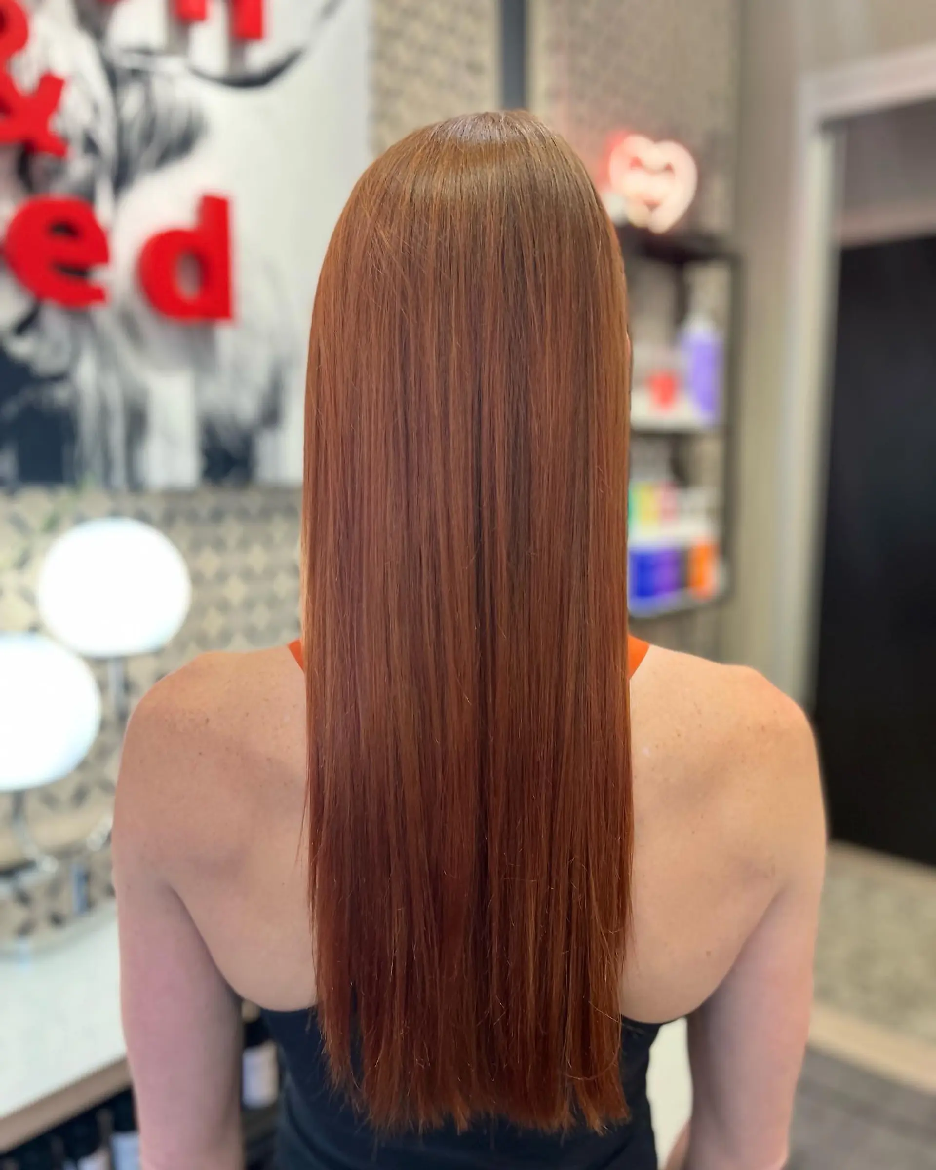 Long, straight, one-length hair with a copper hue and glossy finish. 1