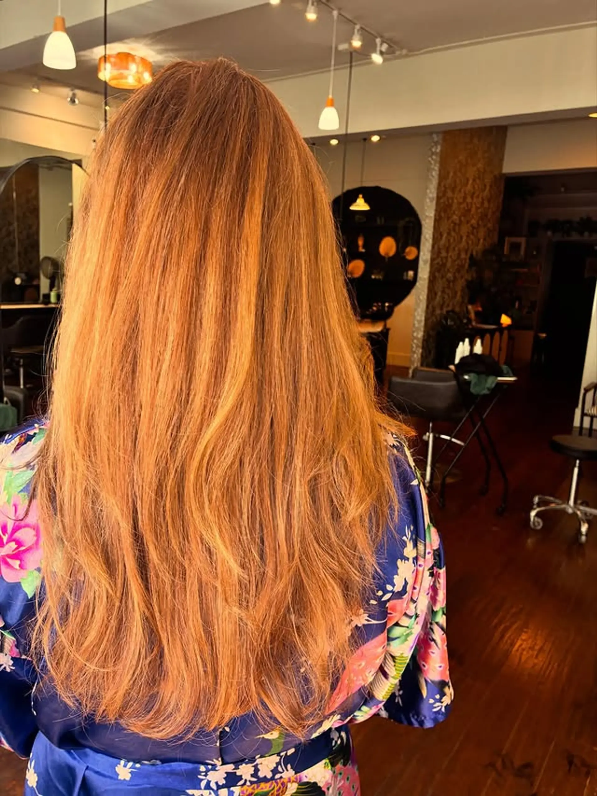 Long layered hairstyle with soft waves and copper color. 1