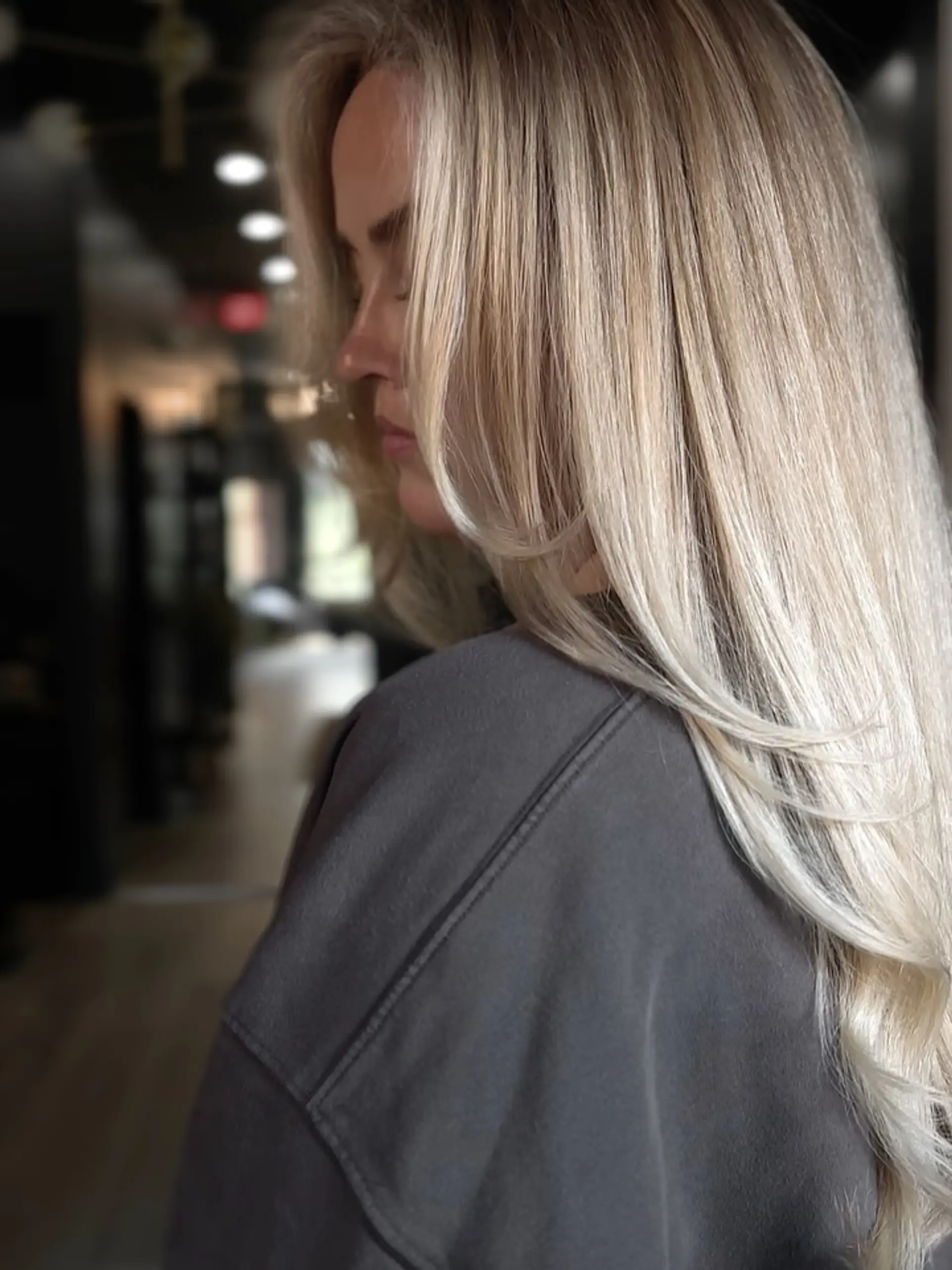 Long, smoothly blown-out blonde hair featuring soft face-framing layers and seamless dimensional highlights. 1