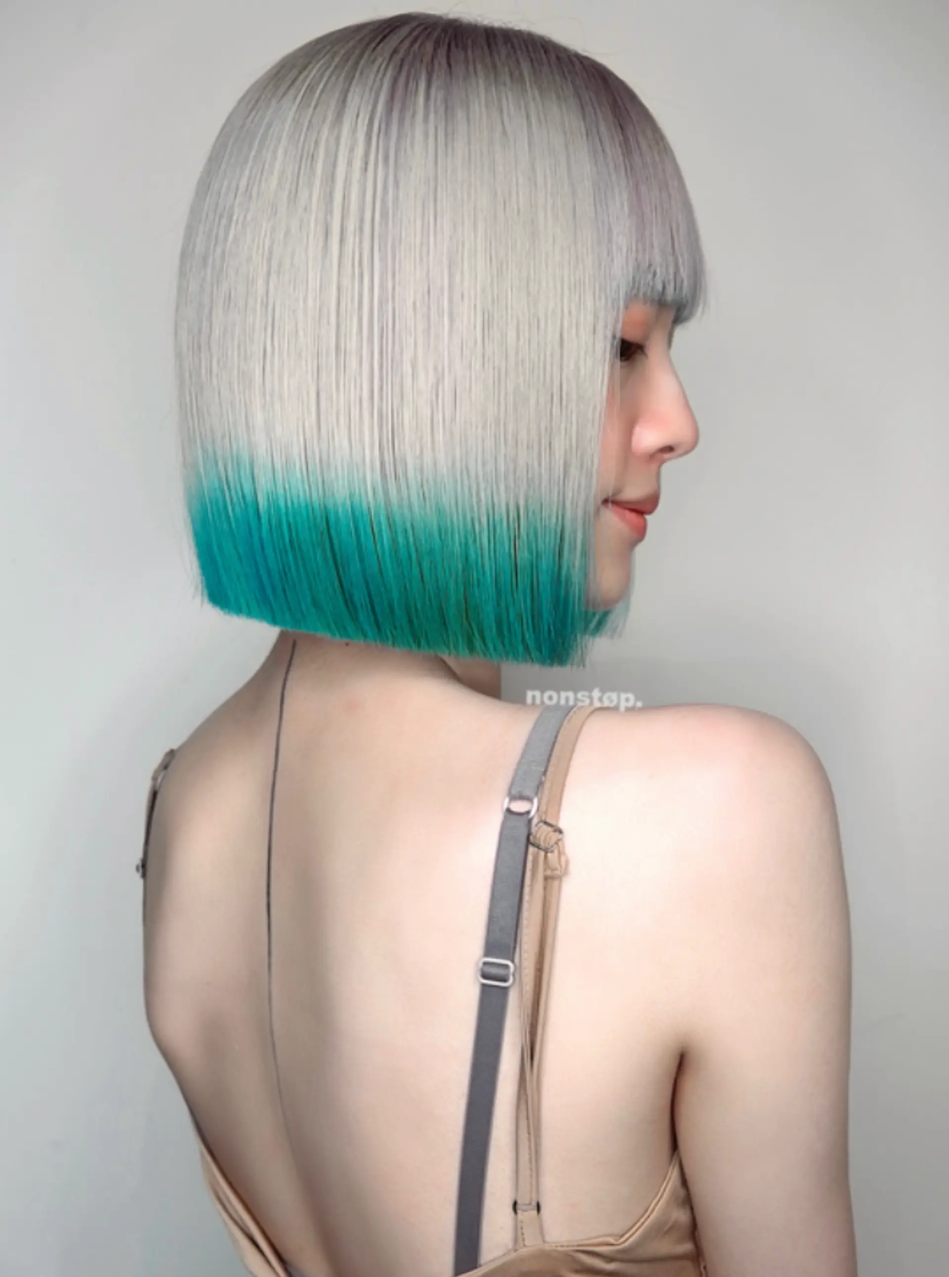 A sleek, straight bob cut with a striking silver base that transitions into vibrant teal tips, creating an ombre gradient effect.
(NonstopStyle: by Hiro) 2