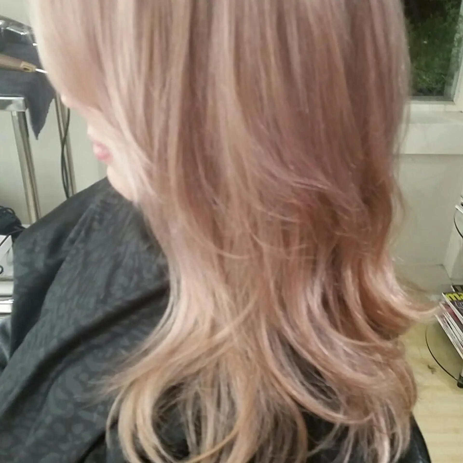 Long layered hair featuring cool-toned icy pink highlights styled in soft waves. 1