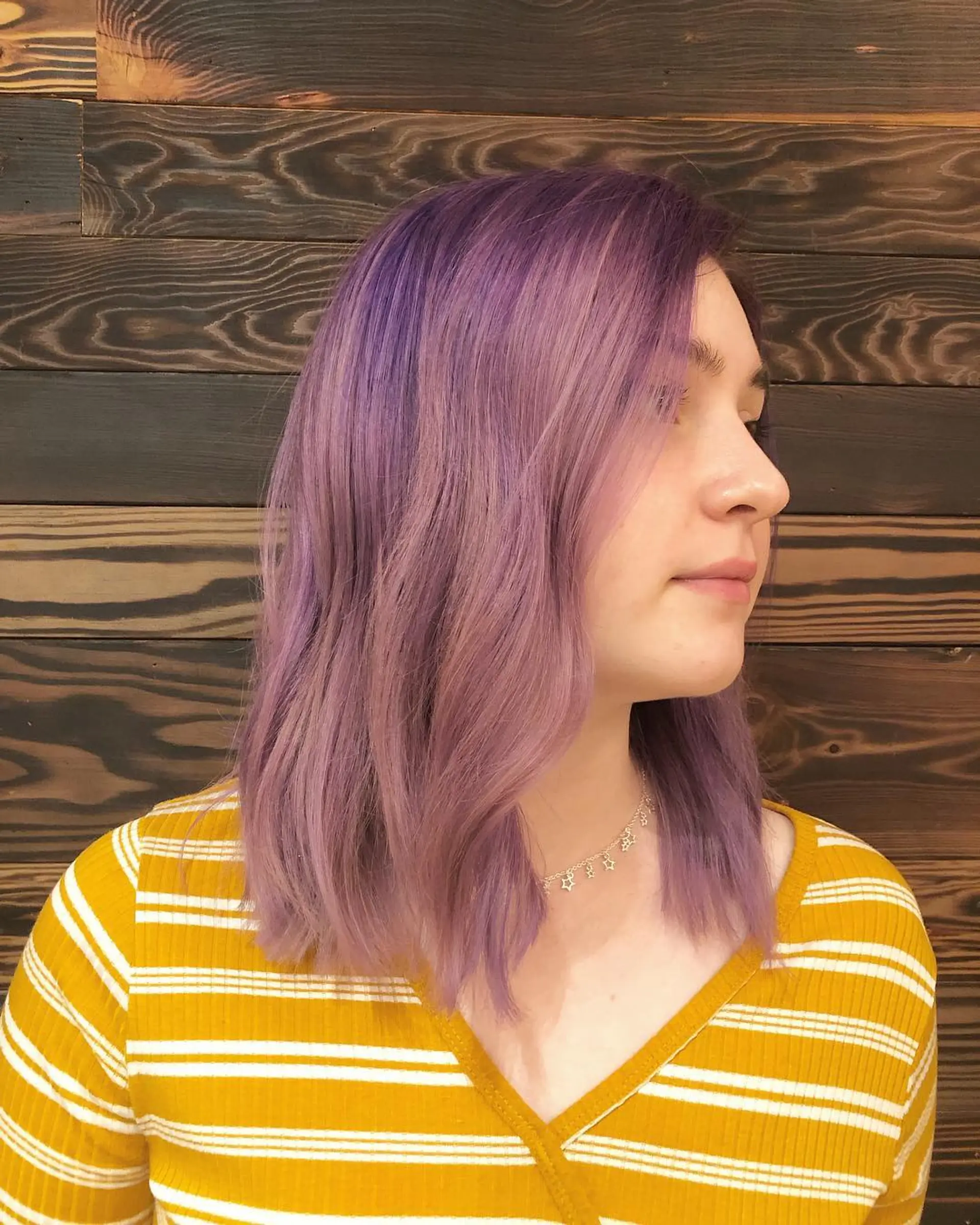 A shoulder-length lob haircut with soft waves and pastel lavender color. 1