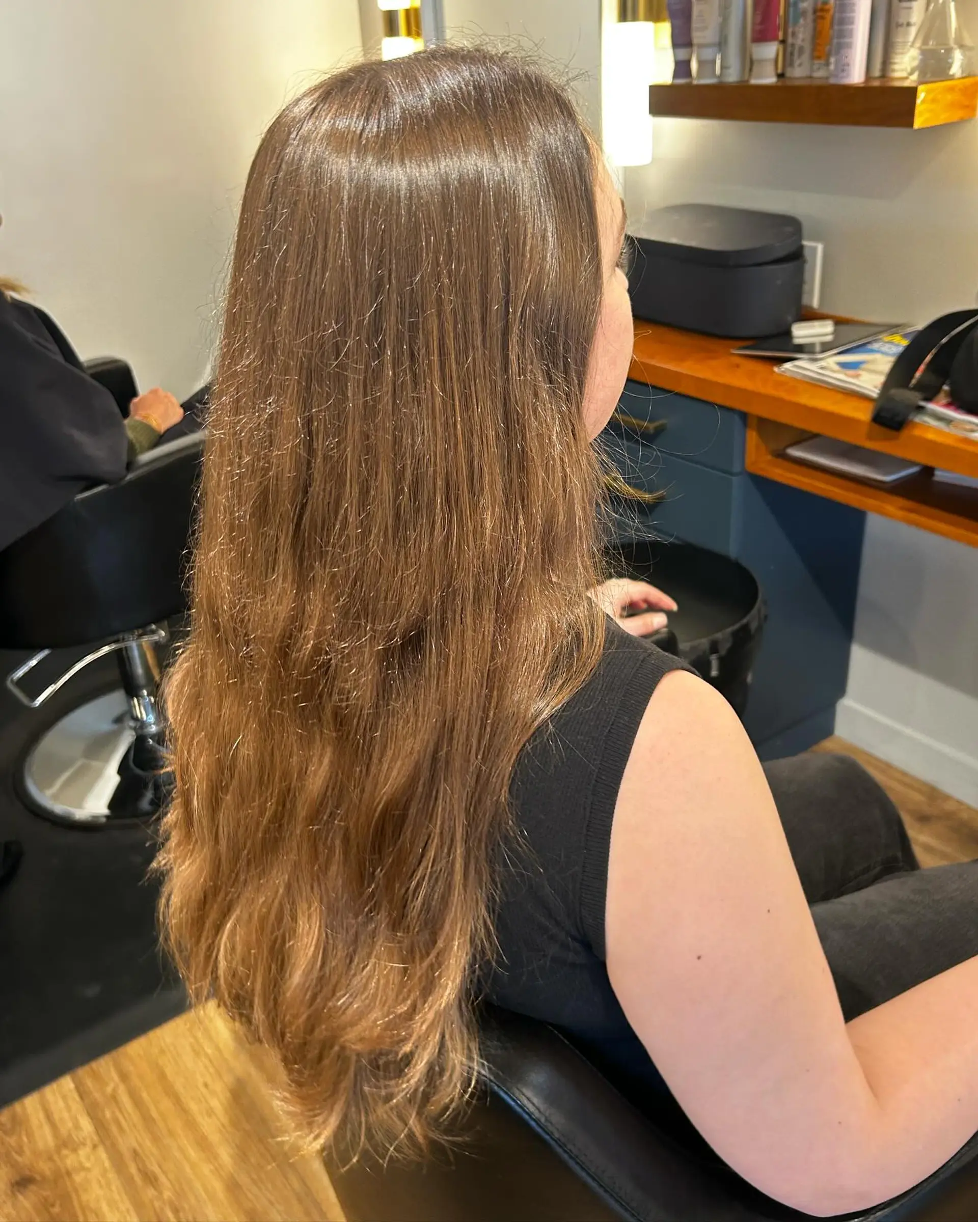 Long warm brunette hair cut with subtle soft layers and natural movement throughout the ends. 1