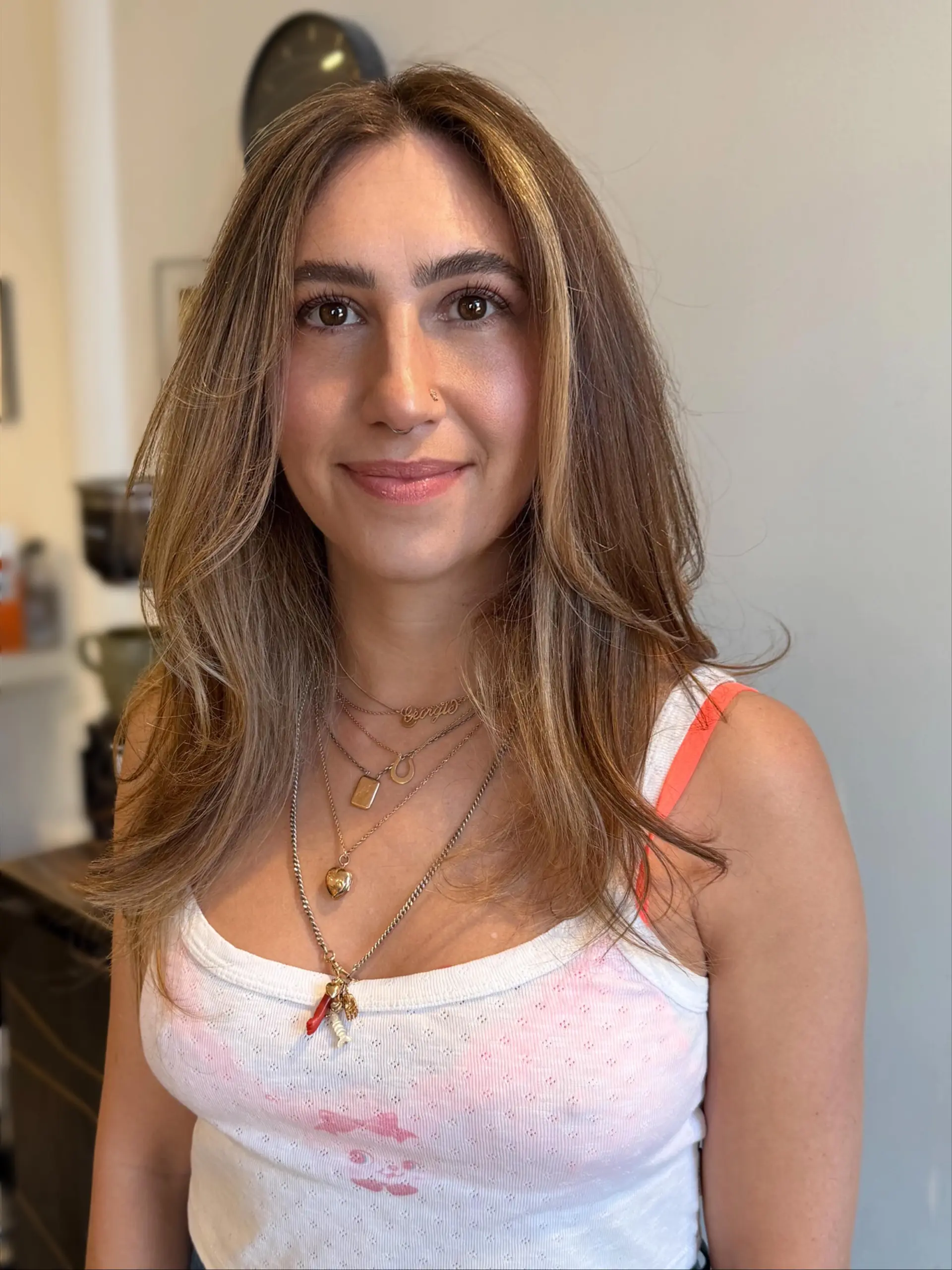 Medium-length layered haircut with subtle face-framing layers and soft, natural movement. 1