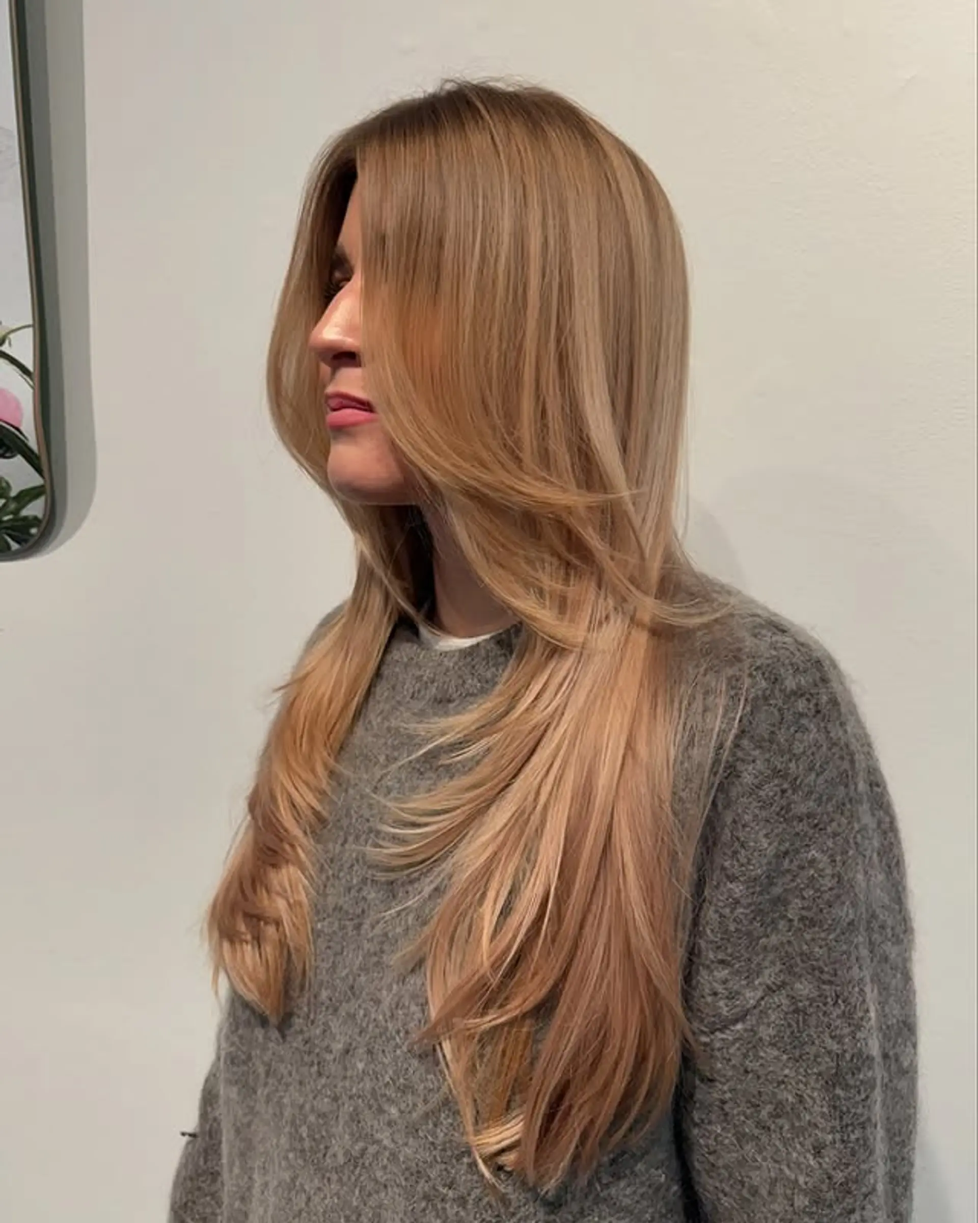 A long, layered haircut with face-framing layers to add volume and movement. 1
