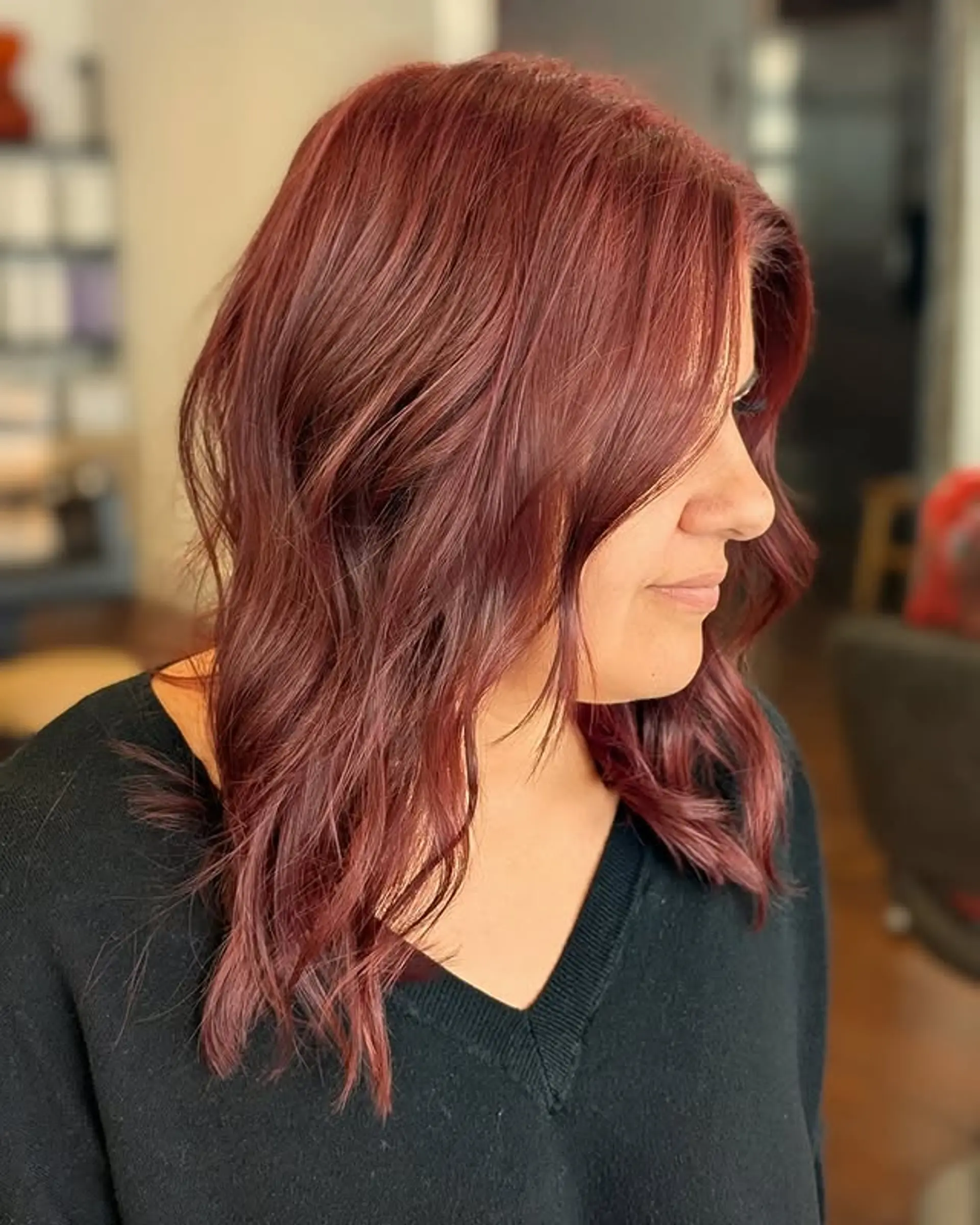 A stylish medium-length wavy hairstyle with a rich auburn color. 1