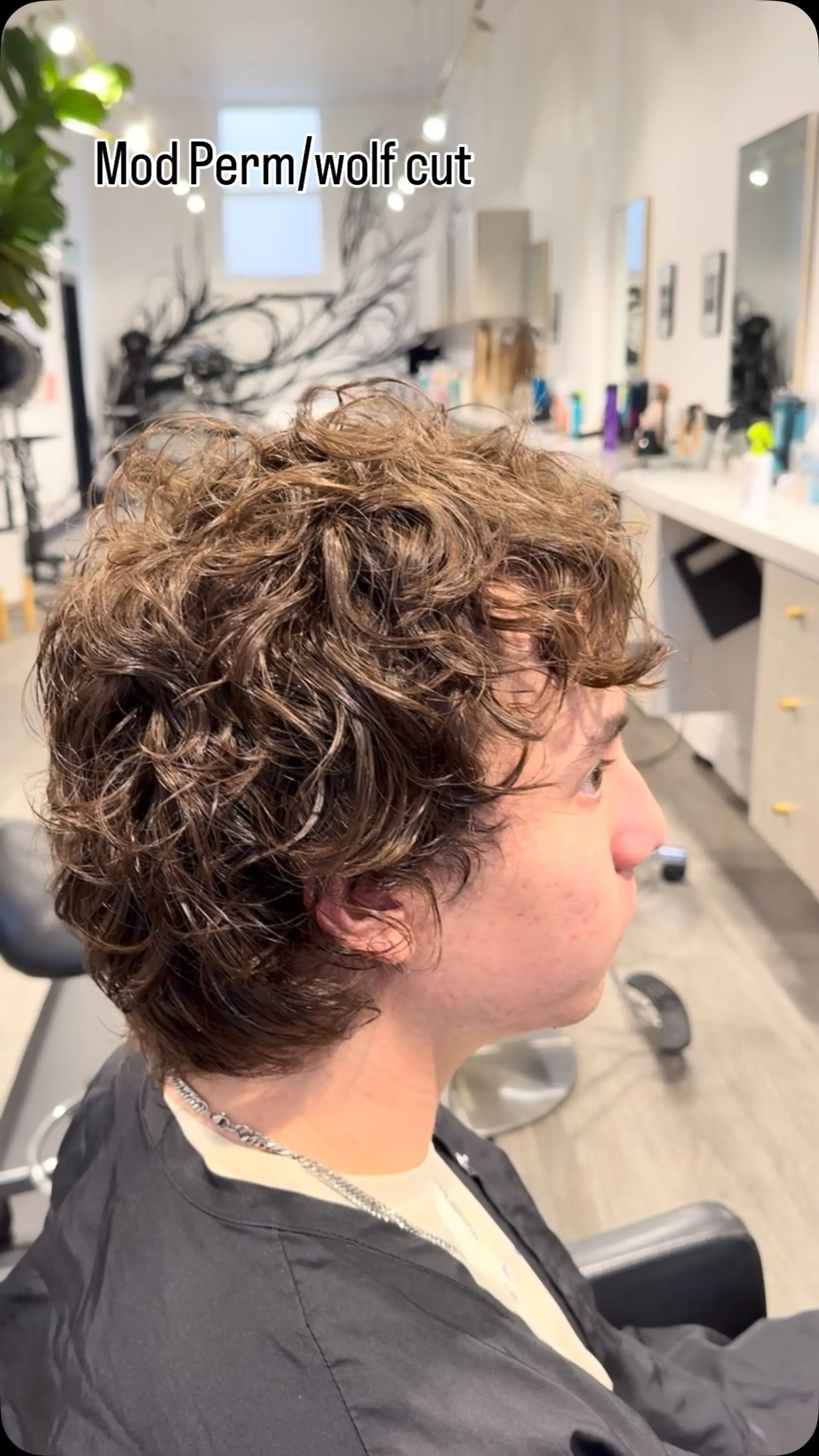 A short, tousled wolf cut enhanced with a custom perm that gives defined texture and volume. 1