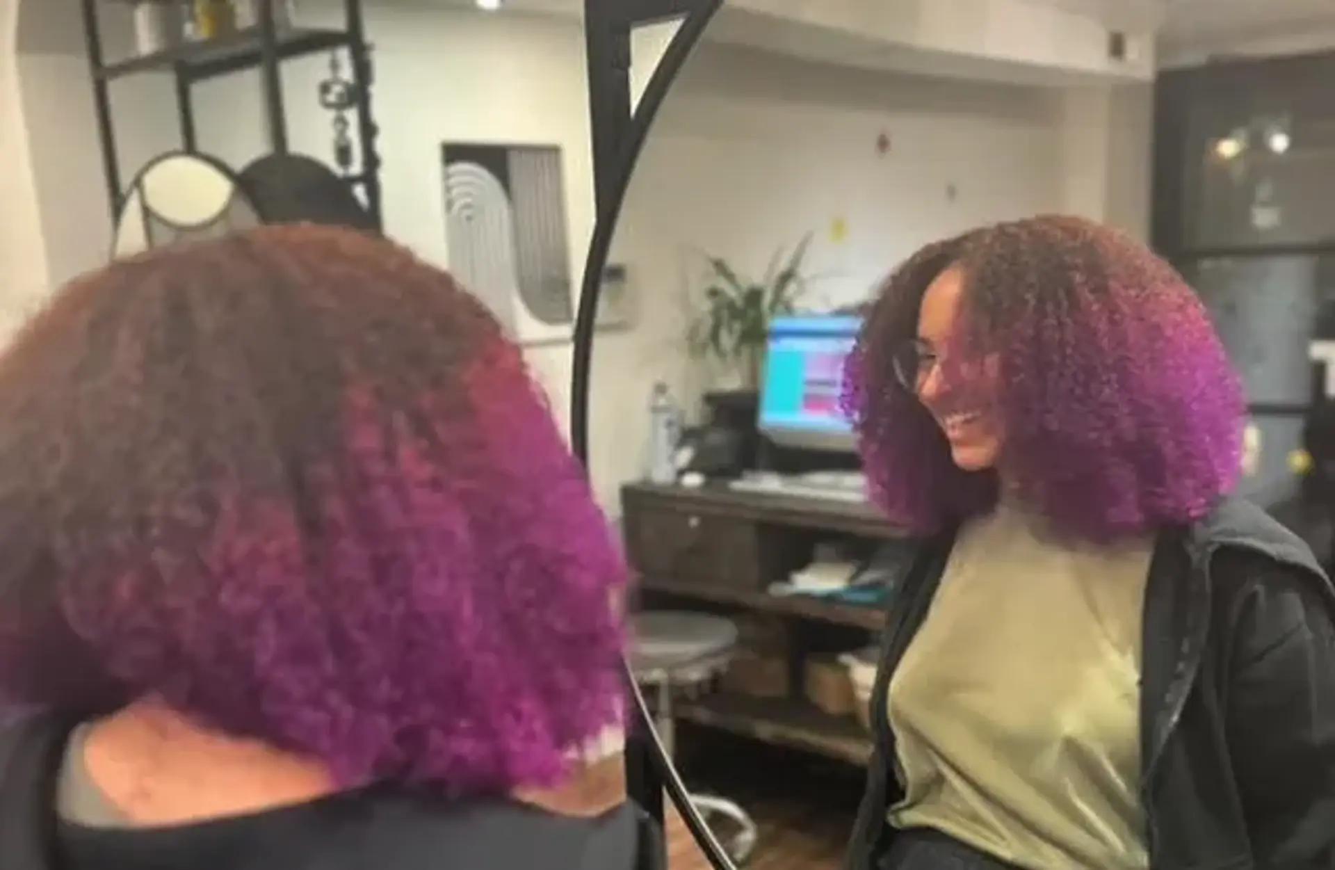 A medium-length kinky, coiled bob with a vibrant purple ombre effect. 1
