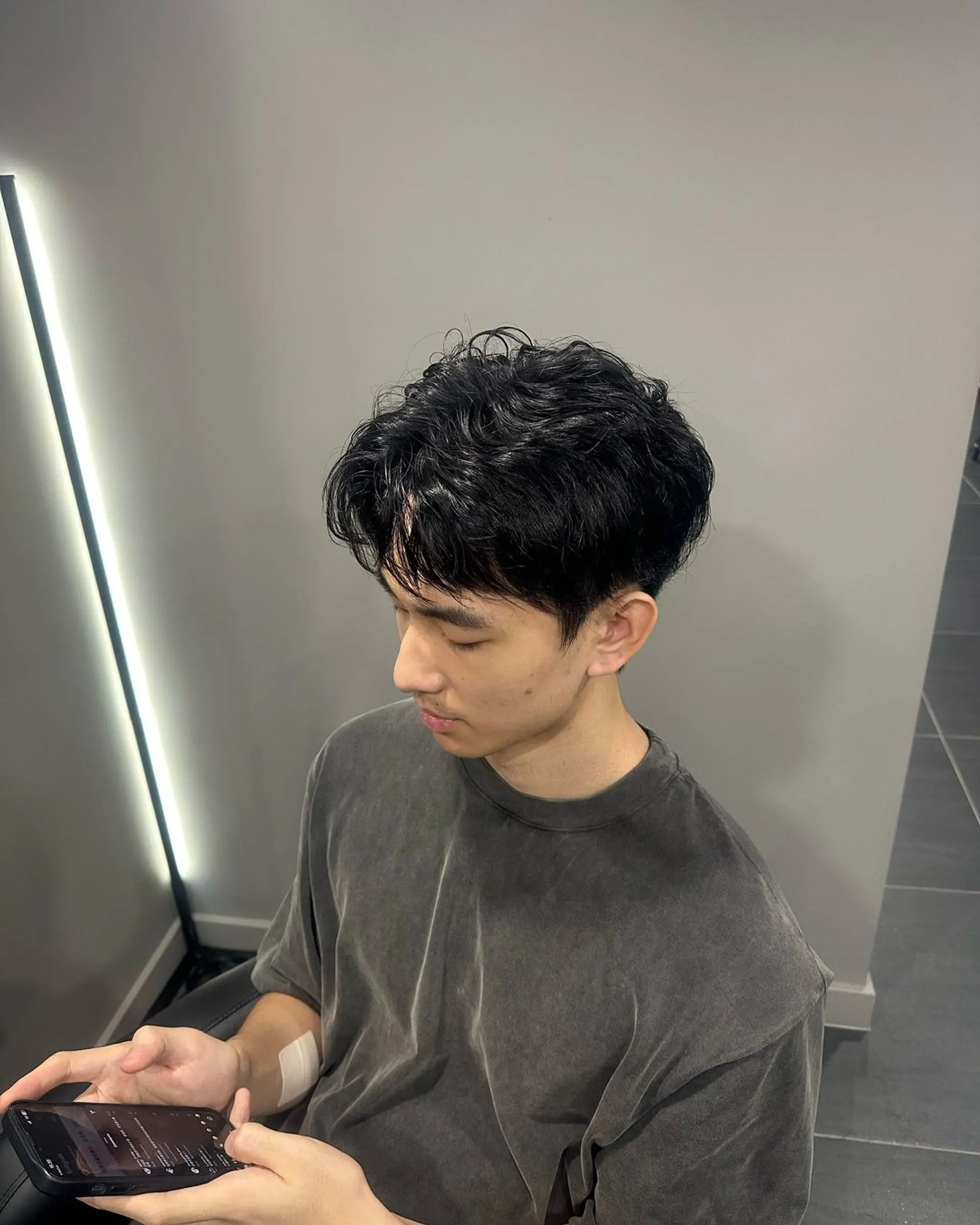 A short, wavy, tousled hairstyle with a textured, casual appearance. The black hair is styled in a laid-back fashion, giving a chic and relaxed vibe. 1