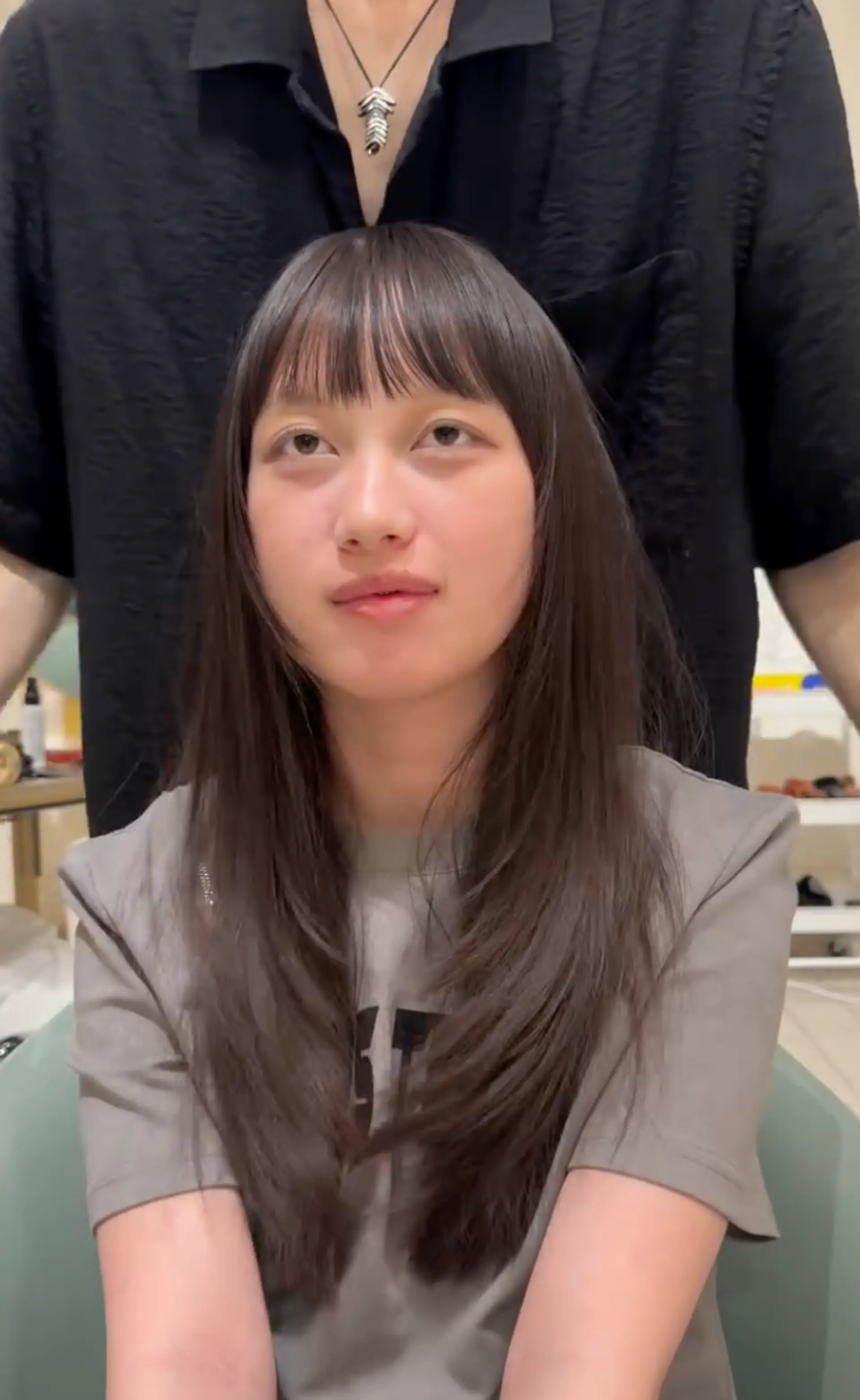 Long, straight, black hair with blunt bangs, a center part, and soft layers. 1