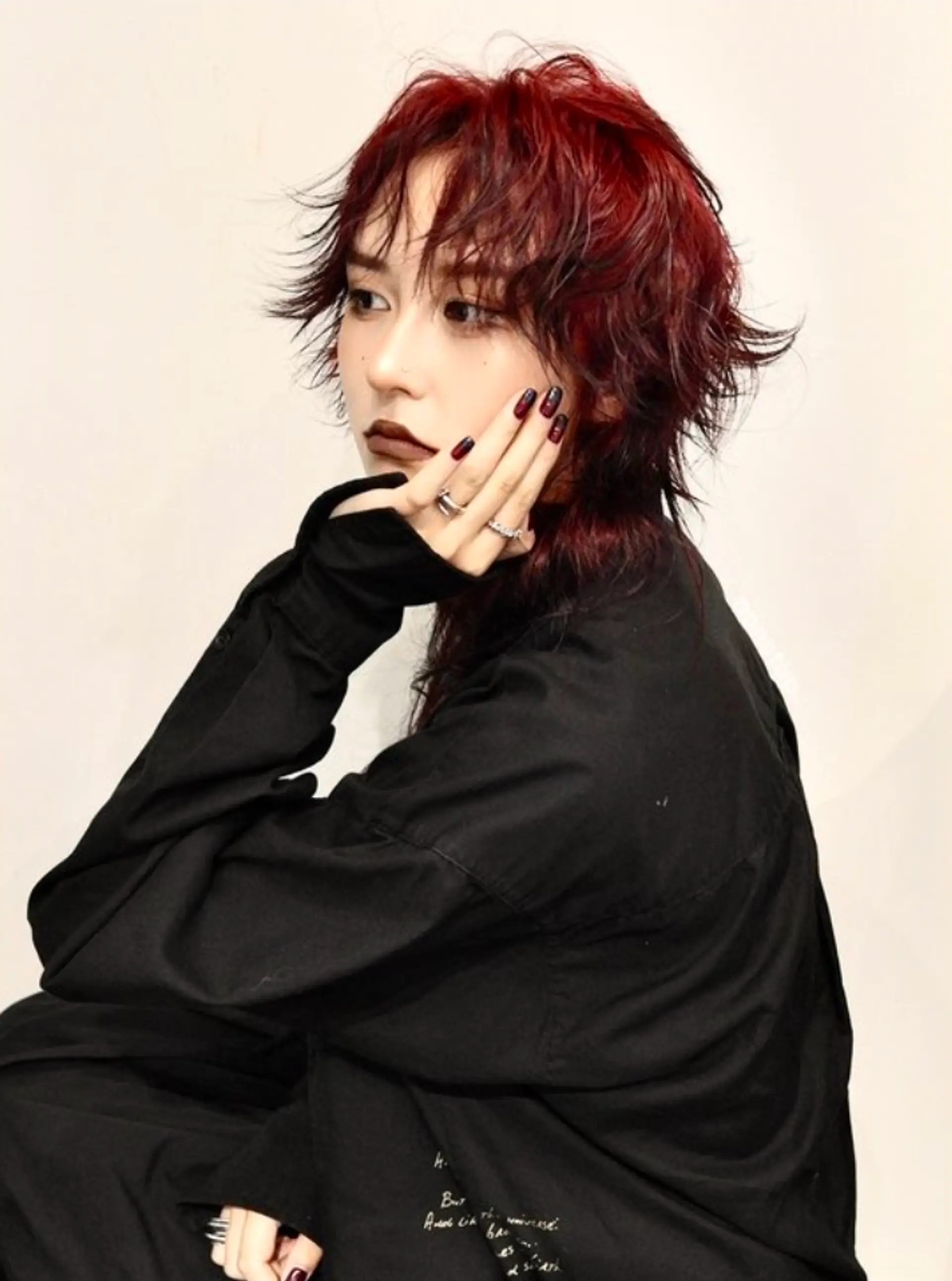 Medium-length wavy hair in crimson red and black, styled in a modern mullet with choppy, textured layers and bold, choppy bangs.

(NonstopStyle: by Kelvin & Vincent) 2