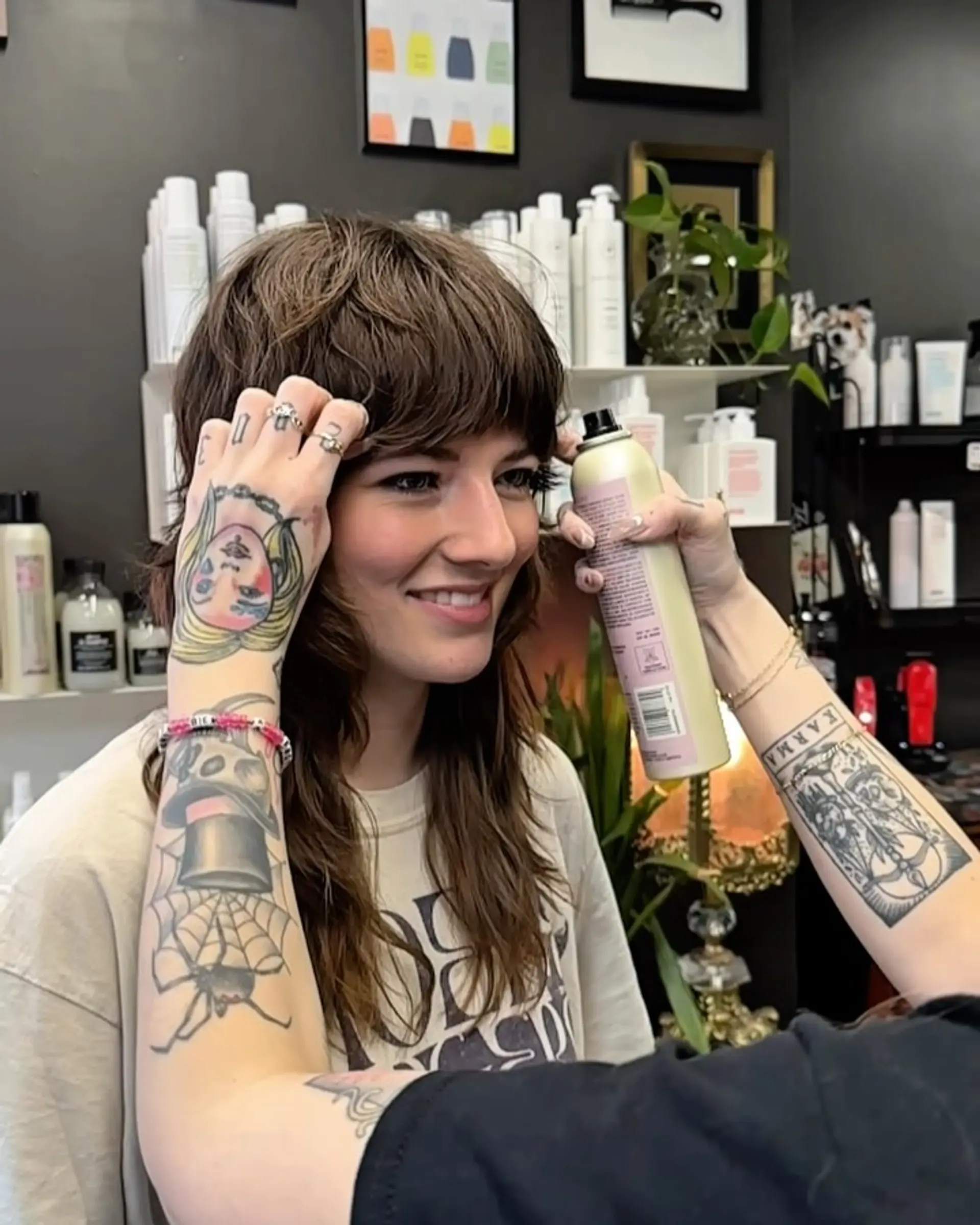 A layered, medium-length shag haircut with heavy textured bangs and piecey face-framing layers. 1