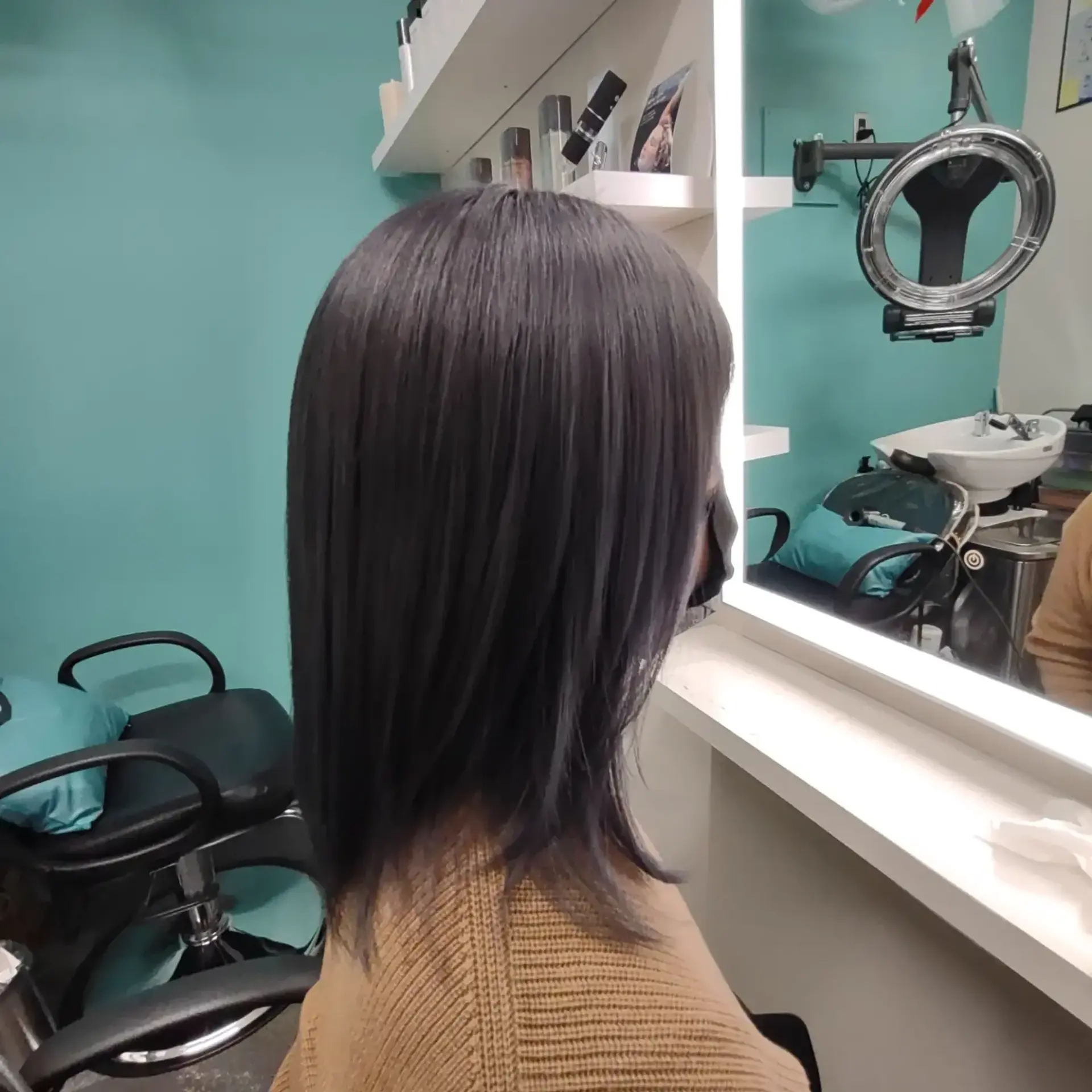 A medium-length straight haircut with soft layering, styled in a sleek cool-toned smokey ash grey finish. 1