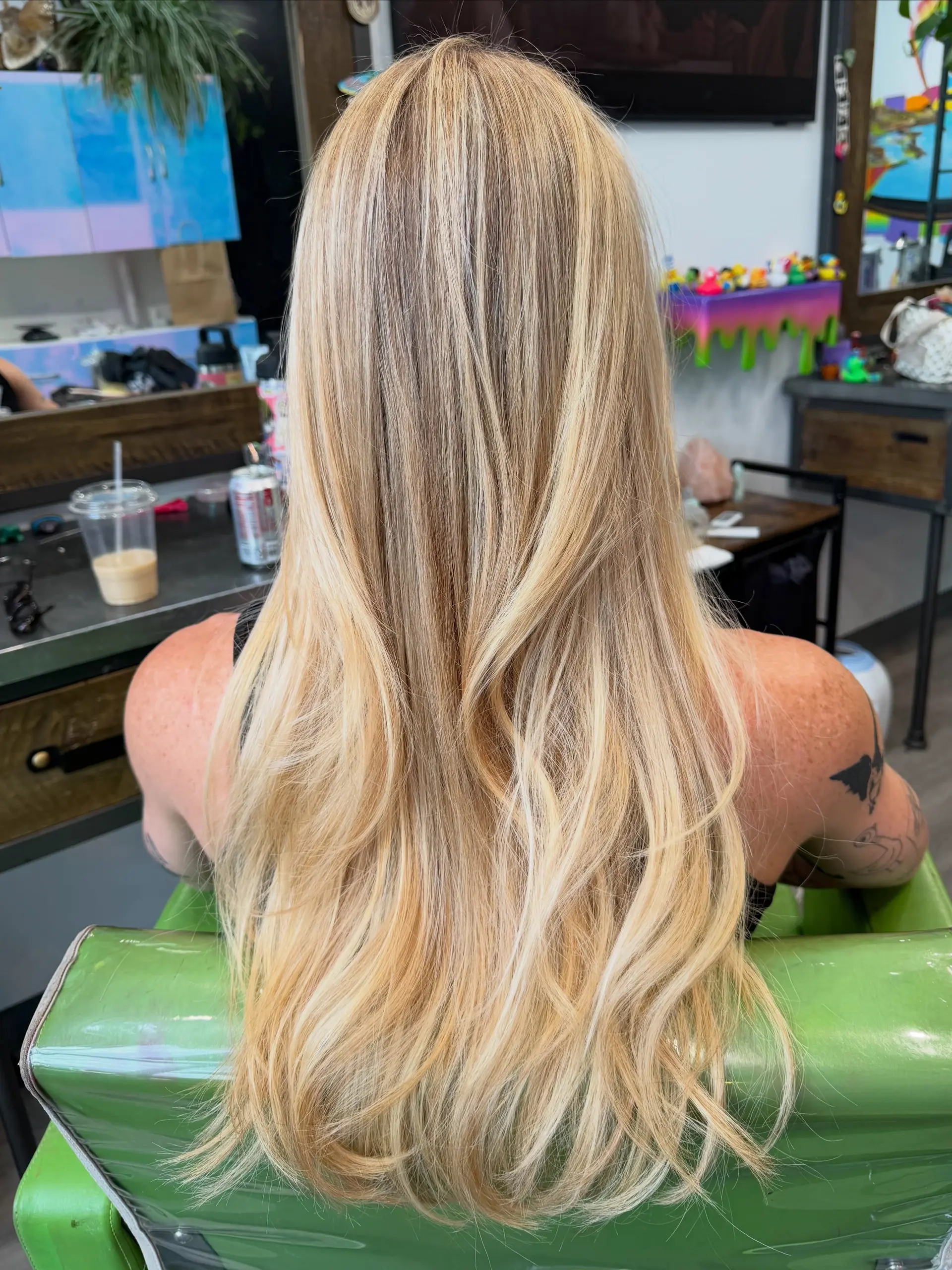 Long blonde hair styled with soft, subtle waves and dimensional multi-tonal highlights. 1