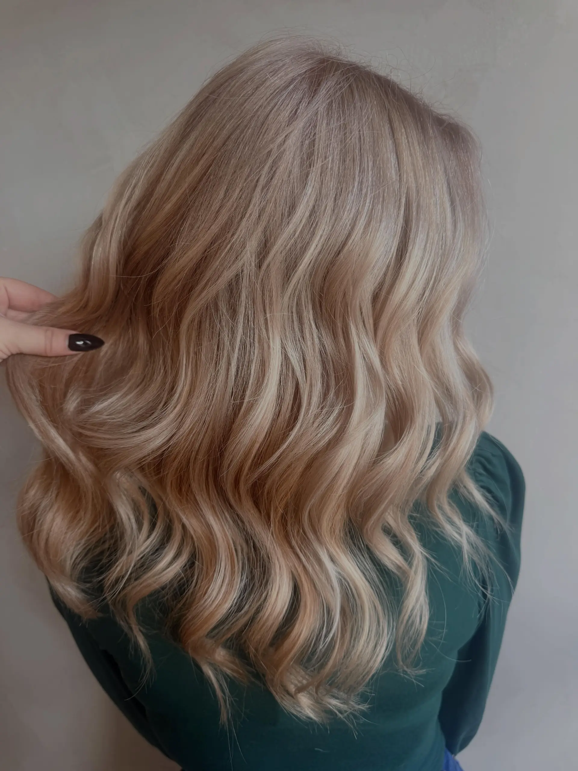 Medium-length soft golden blonde hair styled in loose, textured waves. 1