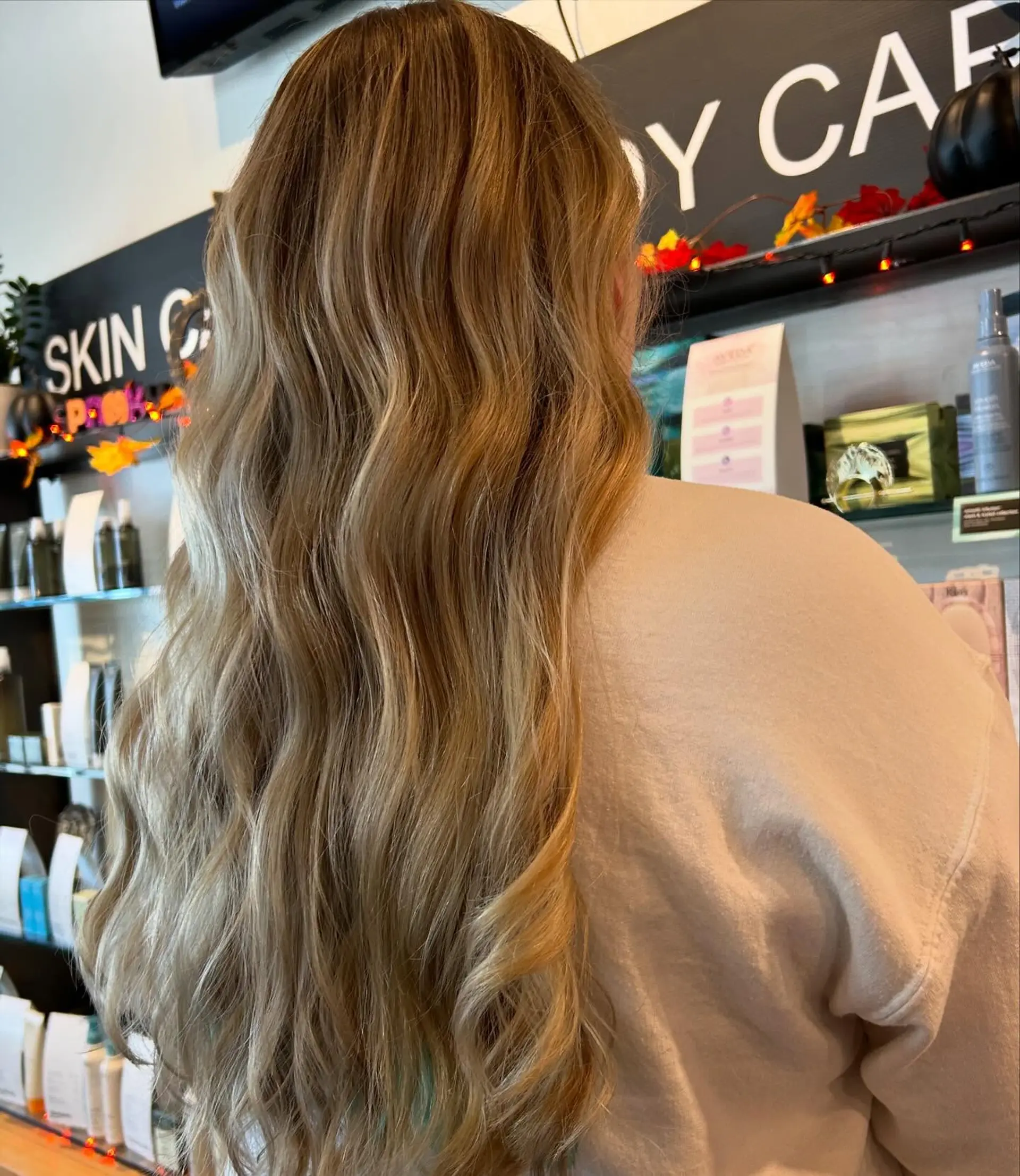 Long, flowing golden honey blonde hair styled in soft, loose waves. 1